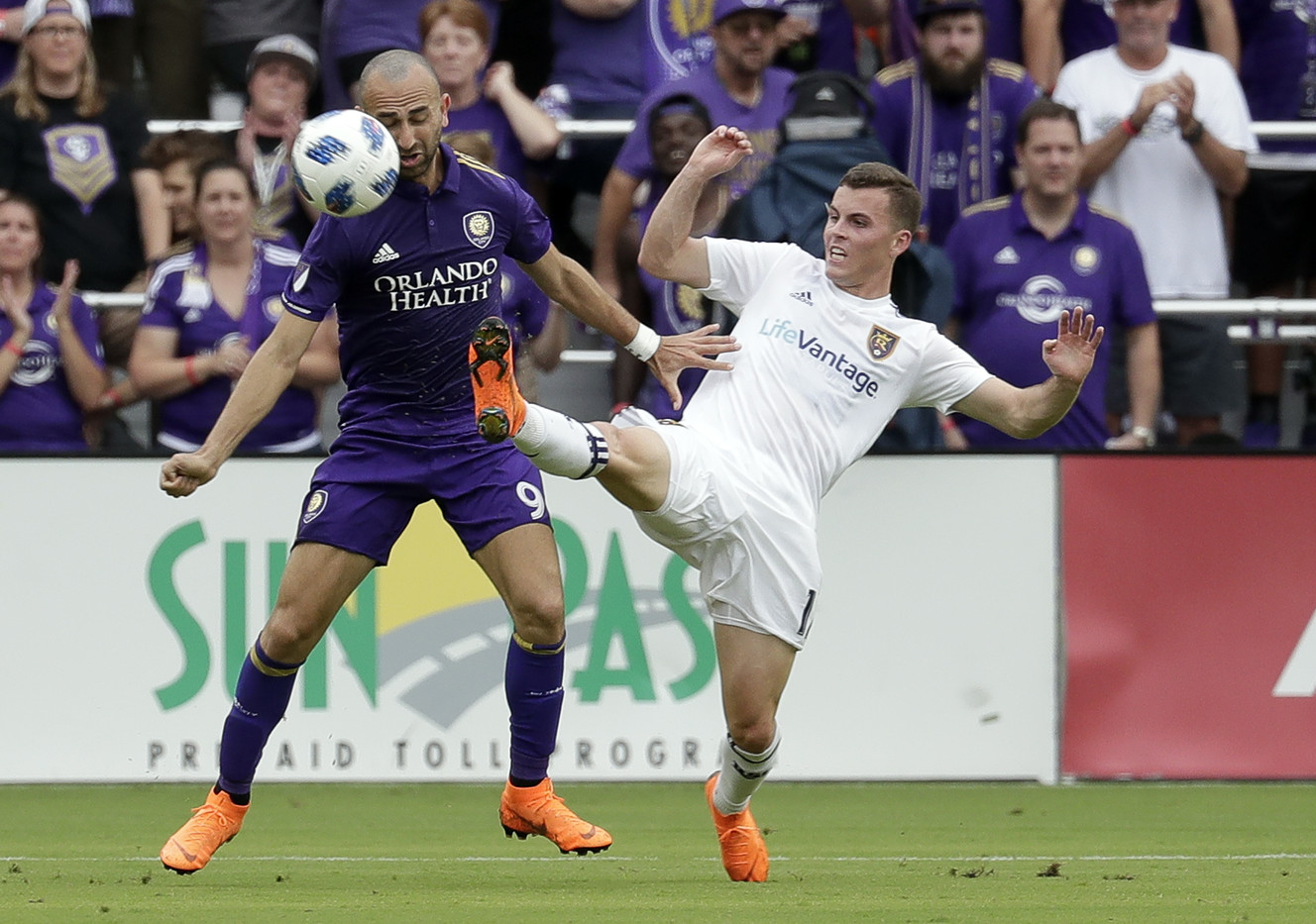 Real Salt Lake's Brooks Lennon, right, clears the ball away from Orlando City's Justin Meram (9) during the first half of an MLS soccer match, Sunday, May 6, 2018, in Orlando, Fla. (AP Photo, John Raoux)