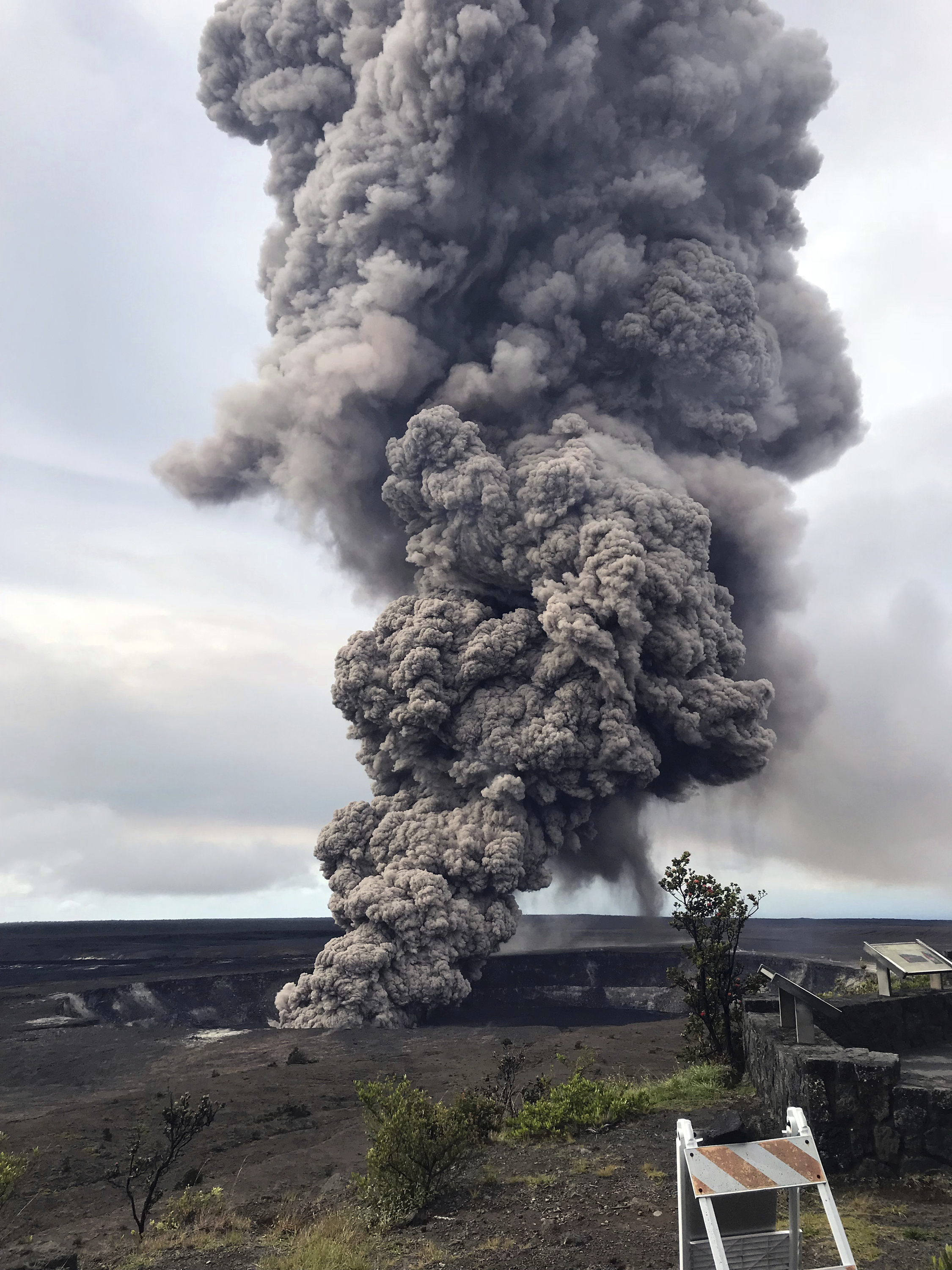 This photo provided by the U.S. Geological Survey shows an ash column rising from the overlook at Halema'uma'u Crater at the summit of Kilauea Volcano in Hawaii Volcanoes National Park on the island of Hawaii at 8:29 a.m. HST Wednesday, May 9, 2018. Hawaii Volcanoes Observatory interprets the short-lived explosion was triggered by a rockfall from the steep walls of the crater. (U.S. Geological Survey via AP)