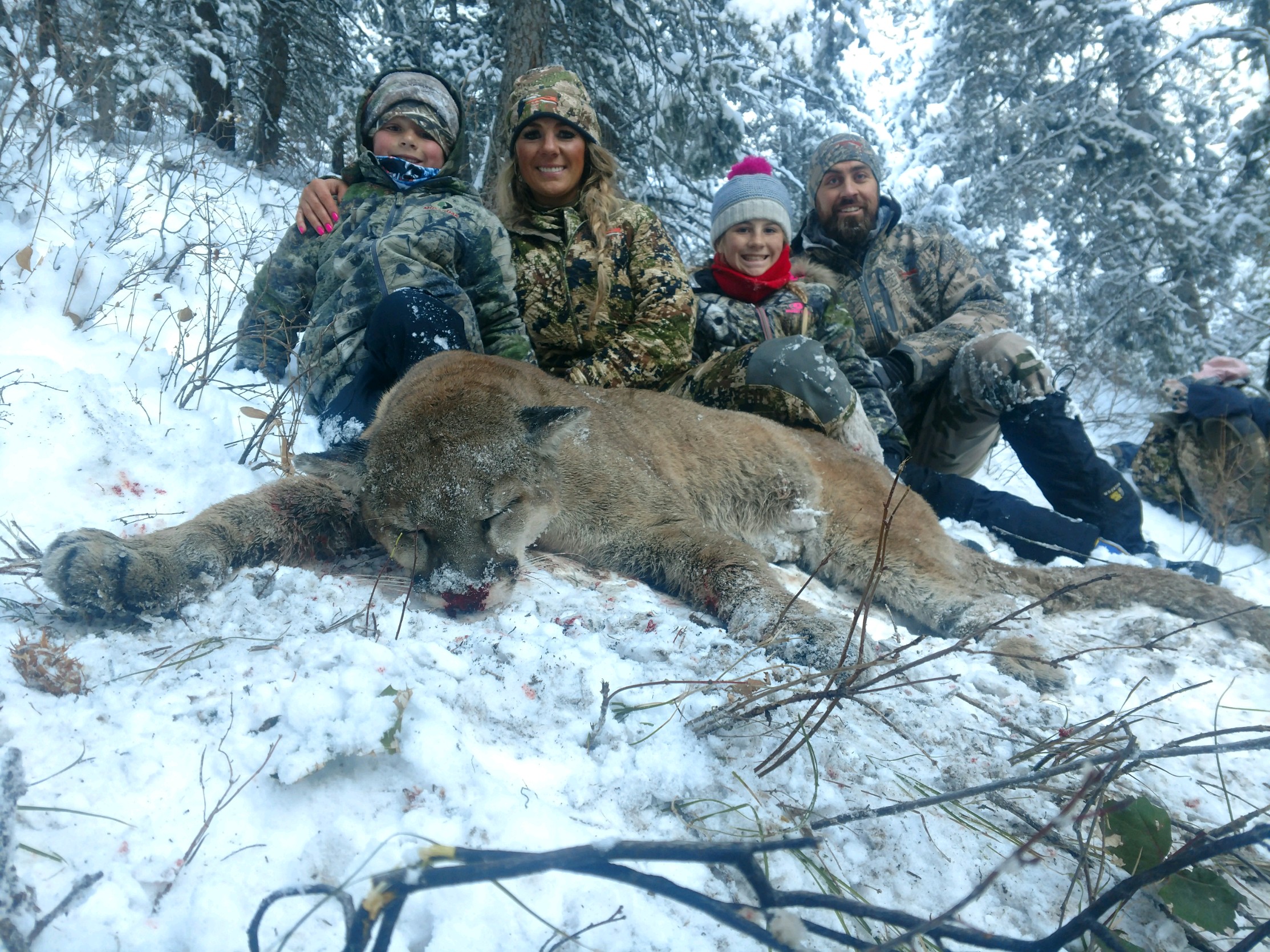 Sheena Cook holding a mountain lion she hunted with a bow earlier in 2018. (Photo courtesy Sheena Cook)