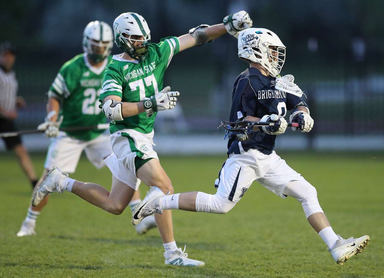 BYU's Chris Severson drives past Michigan State's Ian Genord in lacrosse in Salt Lake City on Thursday, May 10, 2018. (Photo: Jeffrey D. Allred, Deseret News)