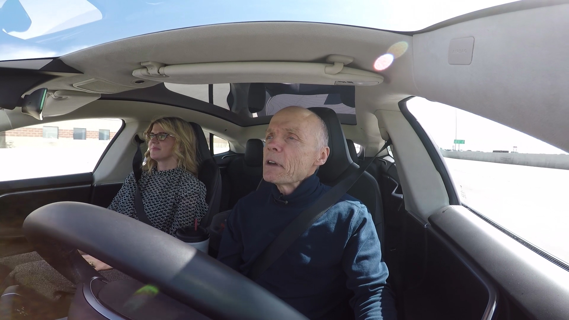 Patrick Wiggins (right) demonstrates autopilot in his Tesla with KSL TV's Heather Simonsen. (Photo: KSL TV)