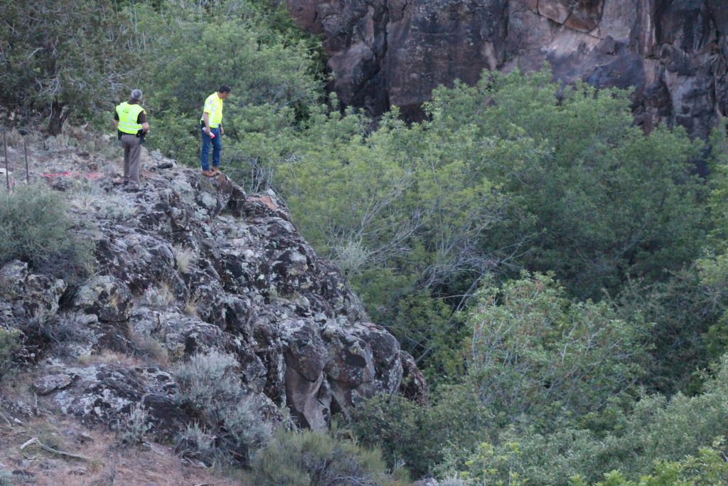 Emergency responders mark the cliff with spray paint where a man's Saturn sedan went off and crashed. The man died as a result of the crash in Veyo, Utah, May 10, 2018. (Photo: Spencer Ricks, St. George News)