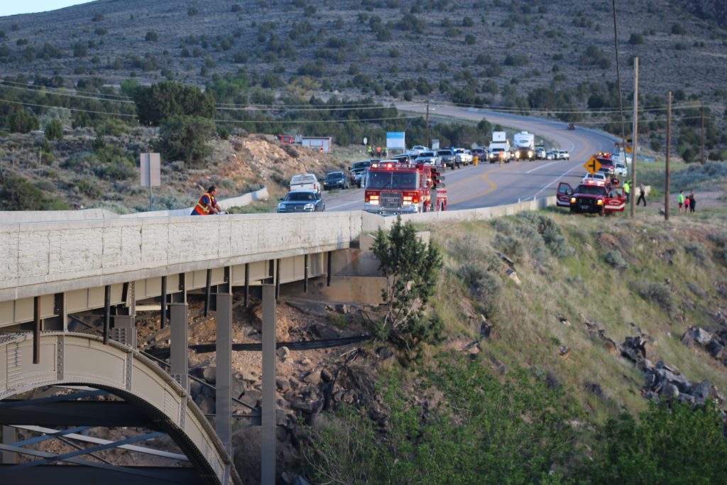 An emergency responder peers off the Veyo Arch Bridge into the ravine where a man died after crashing his car in Veyo, Utah, May 10, 2018. (Photo: Spencer Ricks, St. George News)