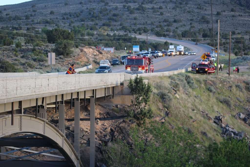 An emergency responder peers off the Veyo Arch Bridge into the ravine where a man died after crashing his car in Veyo, Utah, May 10, 2018. (Photo: Spencer Ricks, St. George News)