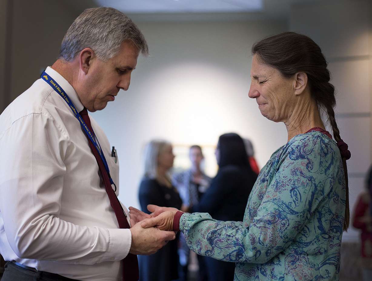 Jody Davis, a chaplain with Rocky Mountain Hospice, left, prays with caregiver Robin Roberts during a Blessing of the Hands at the Huntsman Cancer Institute in Salt Lake City on Friday, May 11, 2018. (Photo: Laura Seitz, KSL)