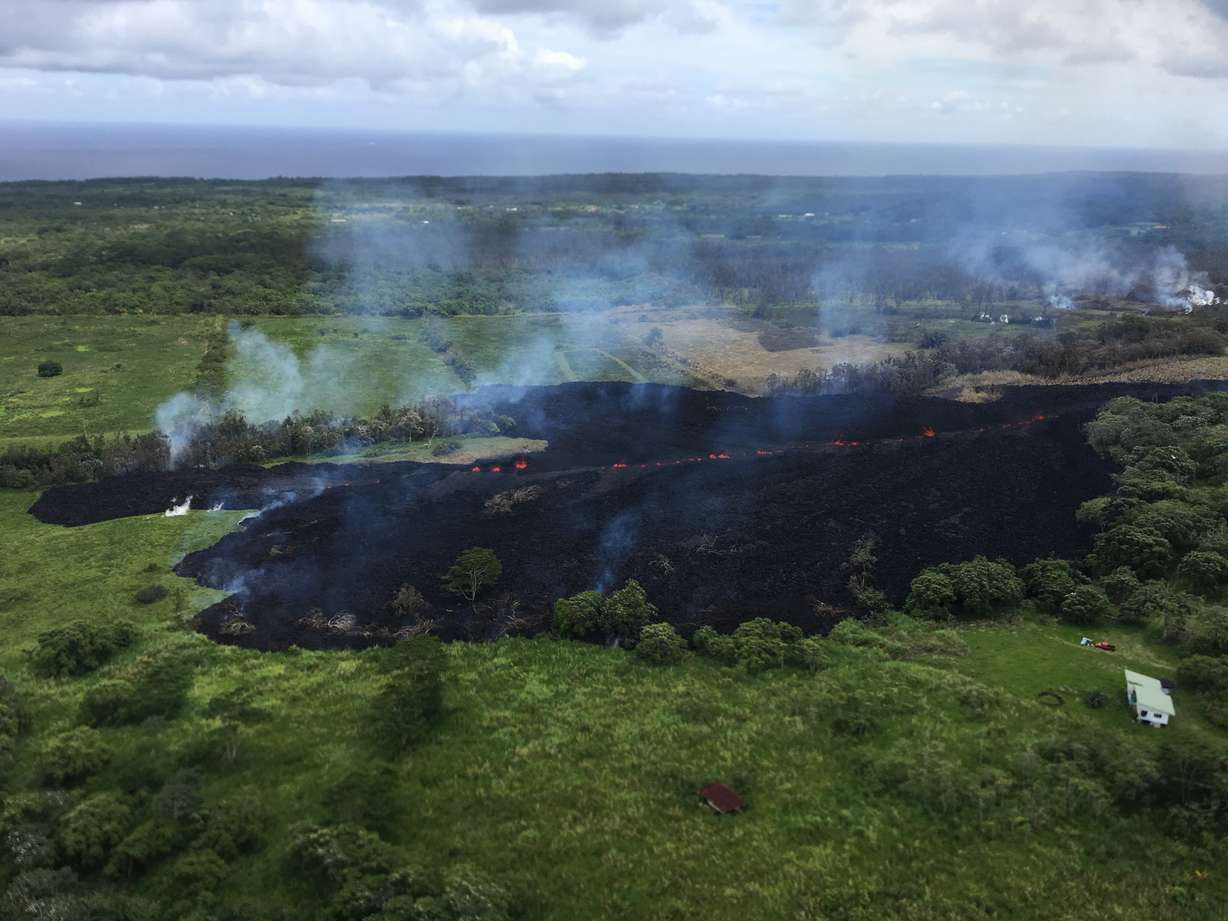 In this May 13, 2018 photo released by the U.S. Geological Survey, gases rise from a fissure near Pahoa, Hawaii. Photo: USGS via AP