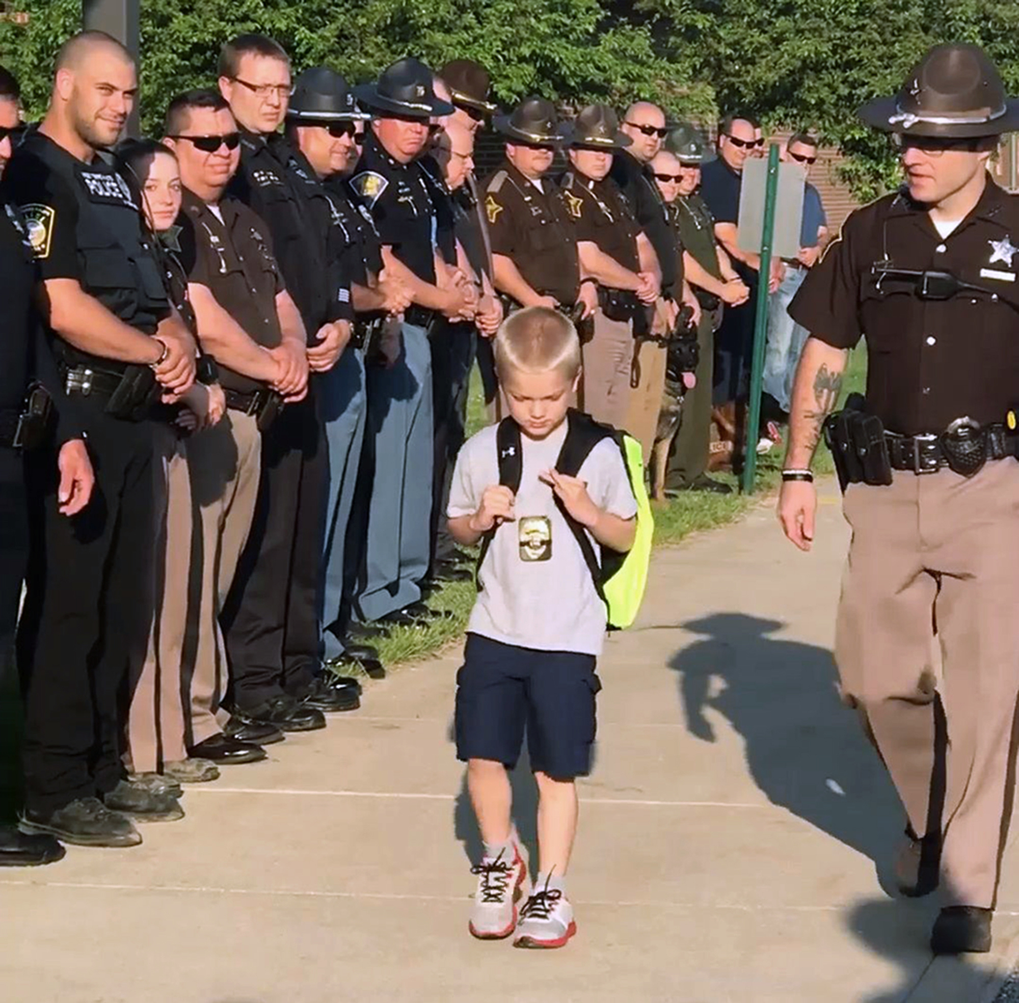 70 officers welcome slain cop's son on his return to school