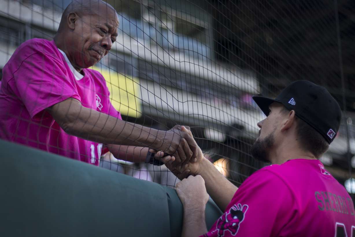 Salt Lake Bees pitcher Taylor Cole offers his condolences to a man in the crowd at Smith's Ballpark after a moment of silence was held for their family member/Larry H. Miller employee who died from cancer earlier this week. (Photo: Carter Williams, KSL.com)