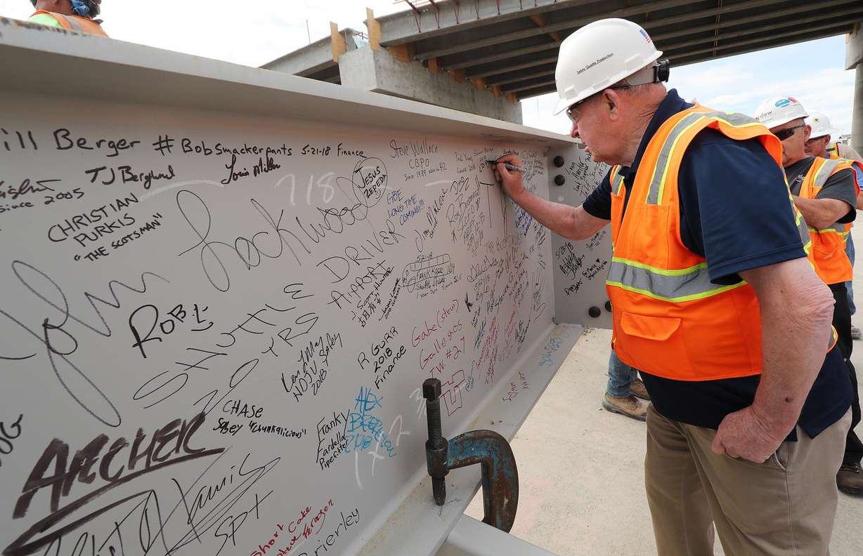 L.D. Bowerman signs the last beam for the new terminal at the Salt Lake City International Airport before it is lifted in place in Salt Lake City on Wednesday, May 23, 2018. (Photo: Jeffrey D. Allred, KSL)