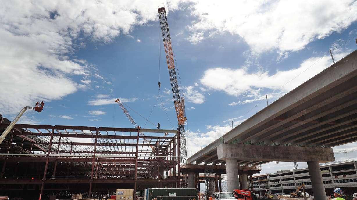 Crews celebrate 'topping out' last beam of new S.L. airport terminal