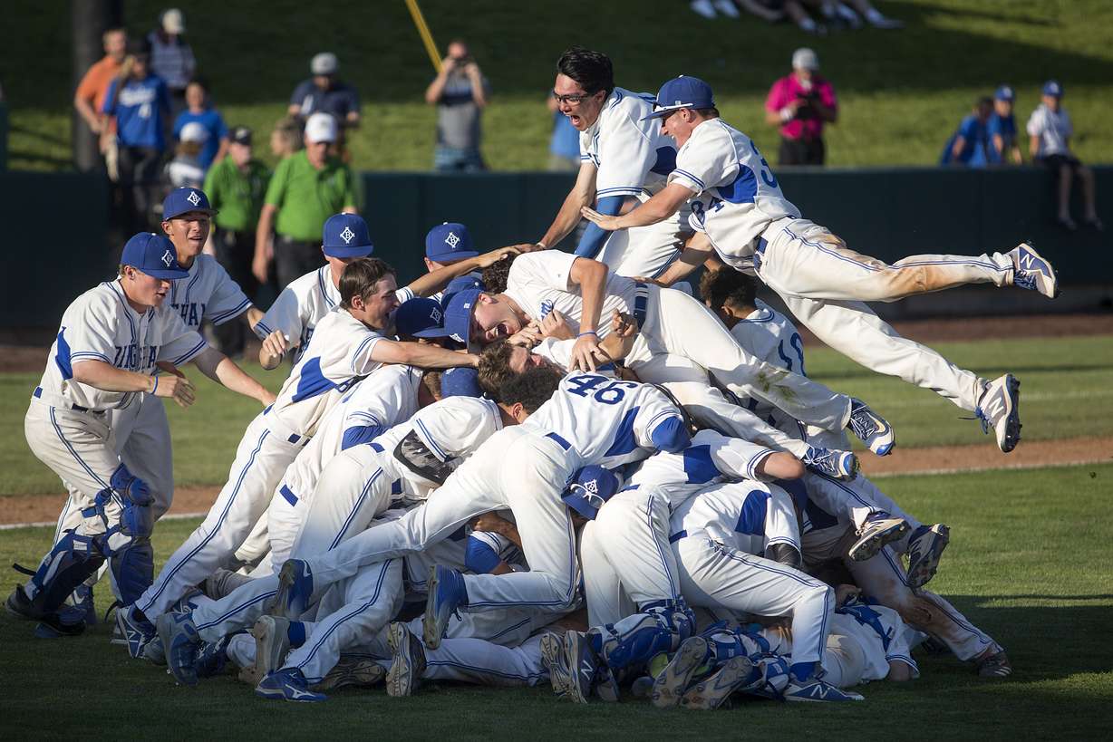 Bingham players dog pile after beating Riverton in the 6A baseball state championship at UCCU Ballpark in Orem on Friday, May 25, 2018. (Photo: James Wooldridge, Deseret News)