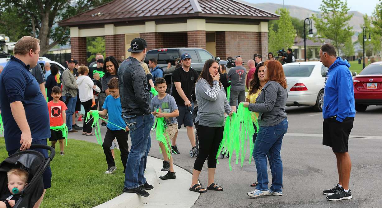 Riverton community members including family and friends of Josh Holt who spent the last two years in a Venezuela prison, gather to place ribbons along 12600 South prior to Josh and his wife Thamy returning home. (Photo: Scott G Winterton, KSL)