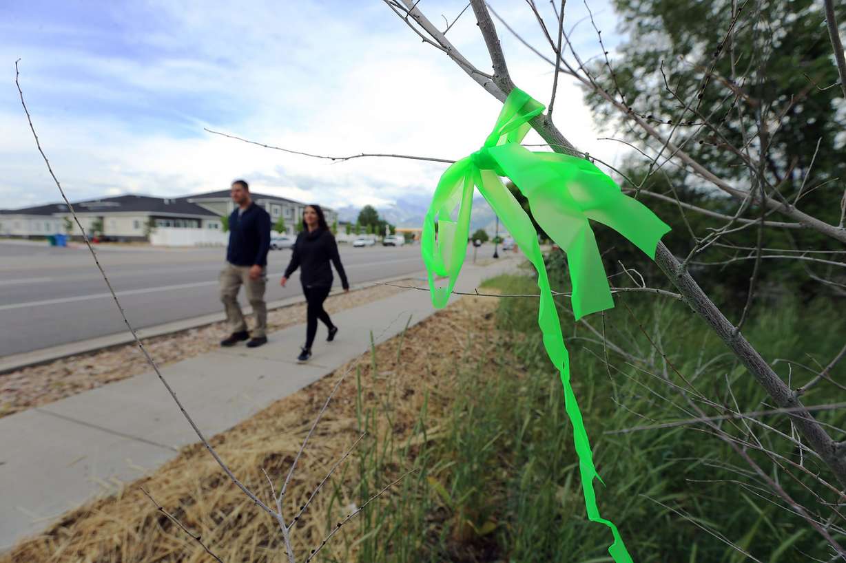 Riverton community members including family and friends of Josh Holt, who spent the last two years in a Venezuela prison, gather to place ribbons along 12600 South on Sunday, May 27, 2018. (Photo: Scott G Winterton, KSL)