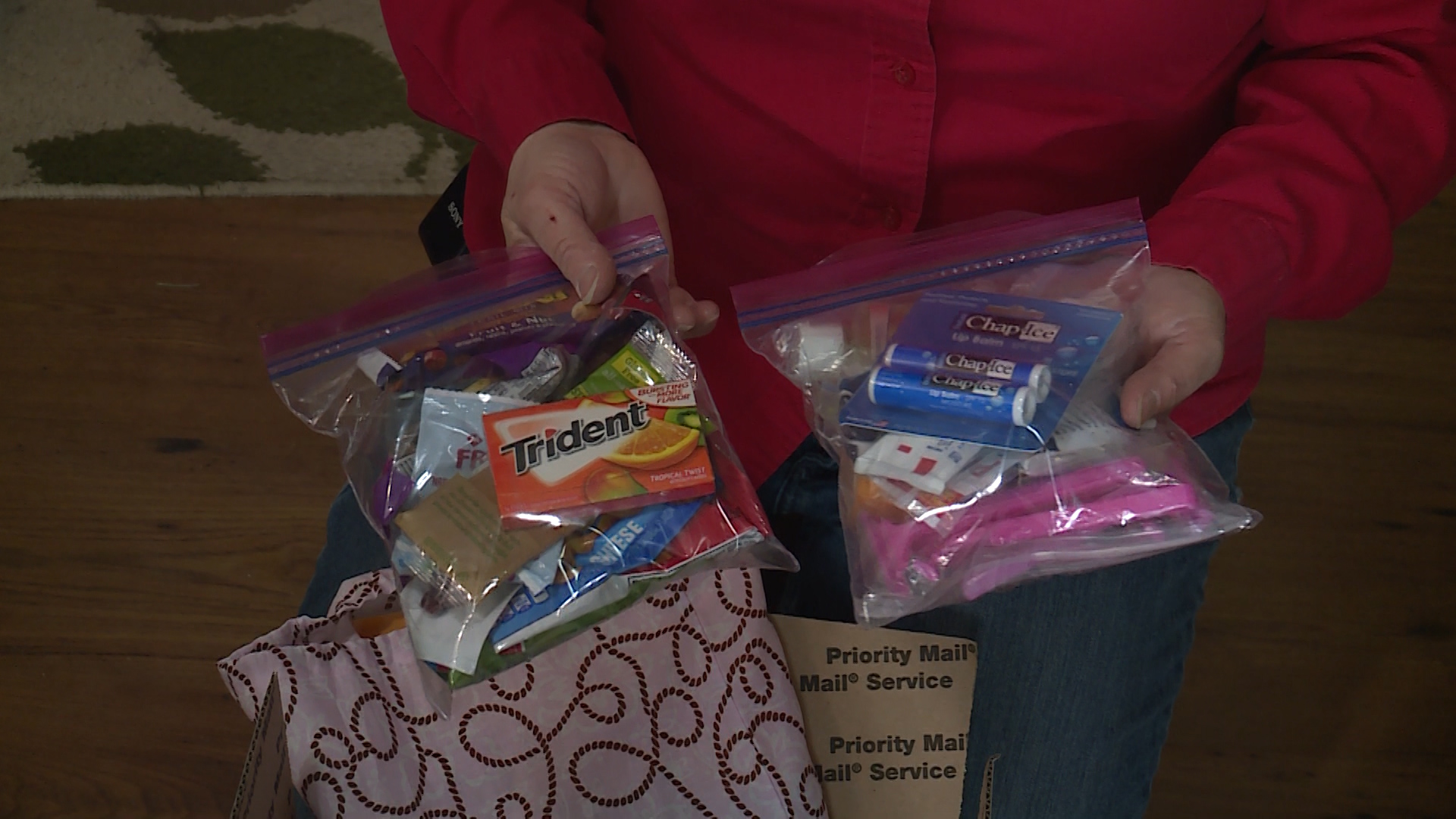 Linda Larsen shows some of the items inside a care package. (Photo: Ray Boone, KSL TV)