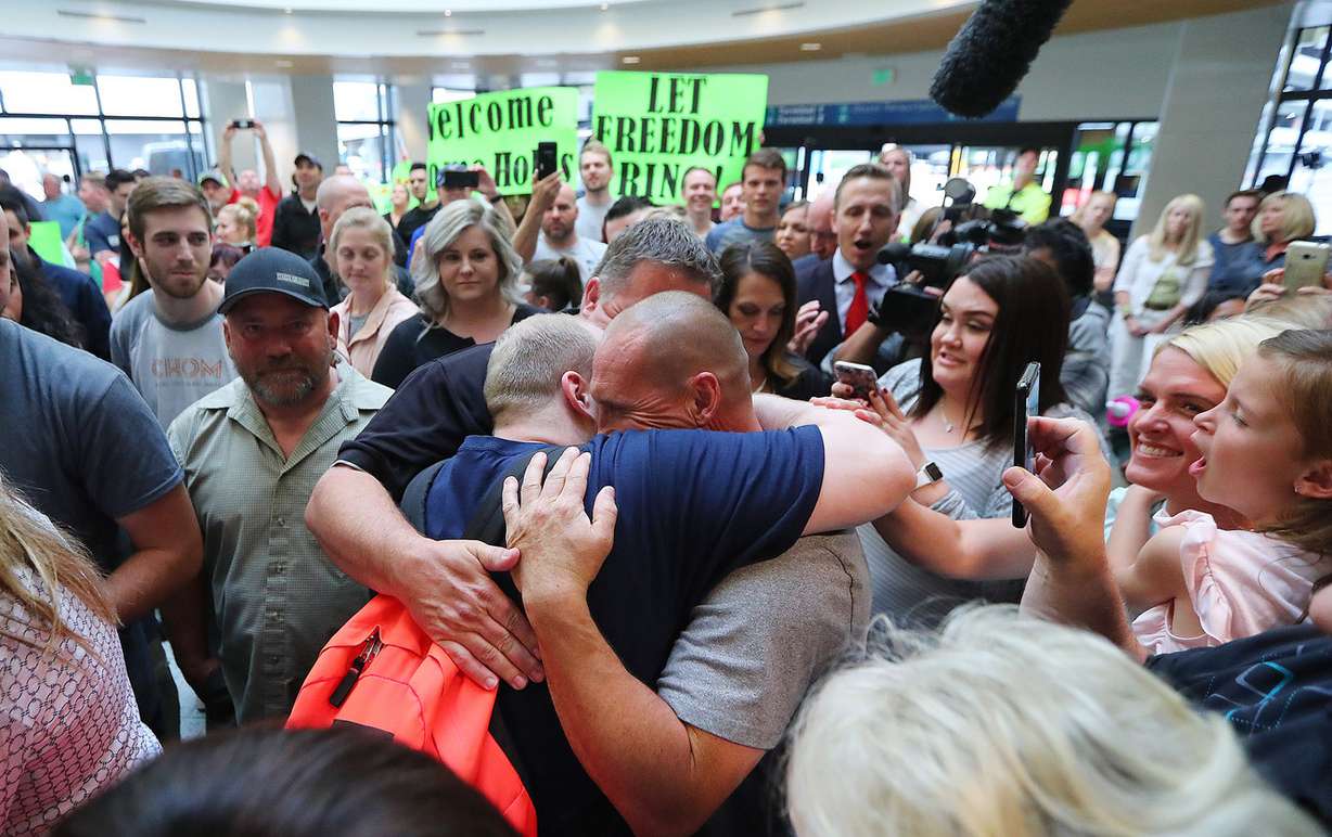 Josh Holt and his wife Thamy are swarmed by family and friends at the International Terminal in Salt Lake City International Airport on Monday, May 28, 2018. (Photo: Scott G Winterton, KSL)