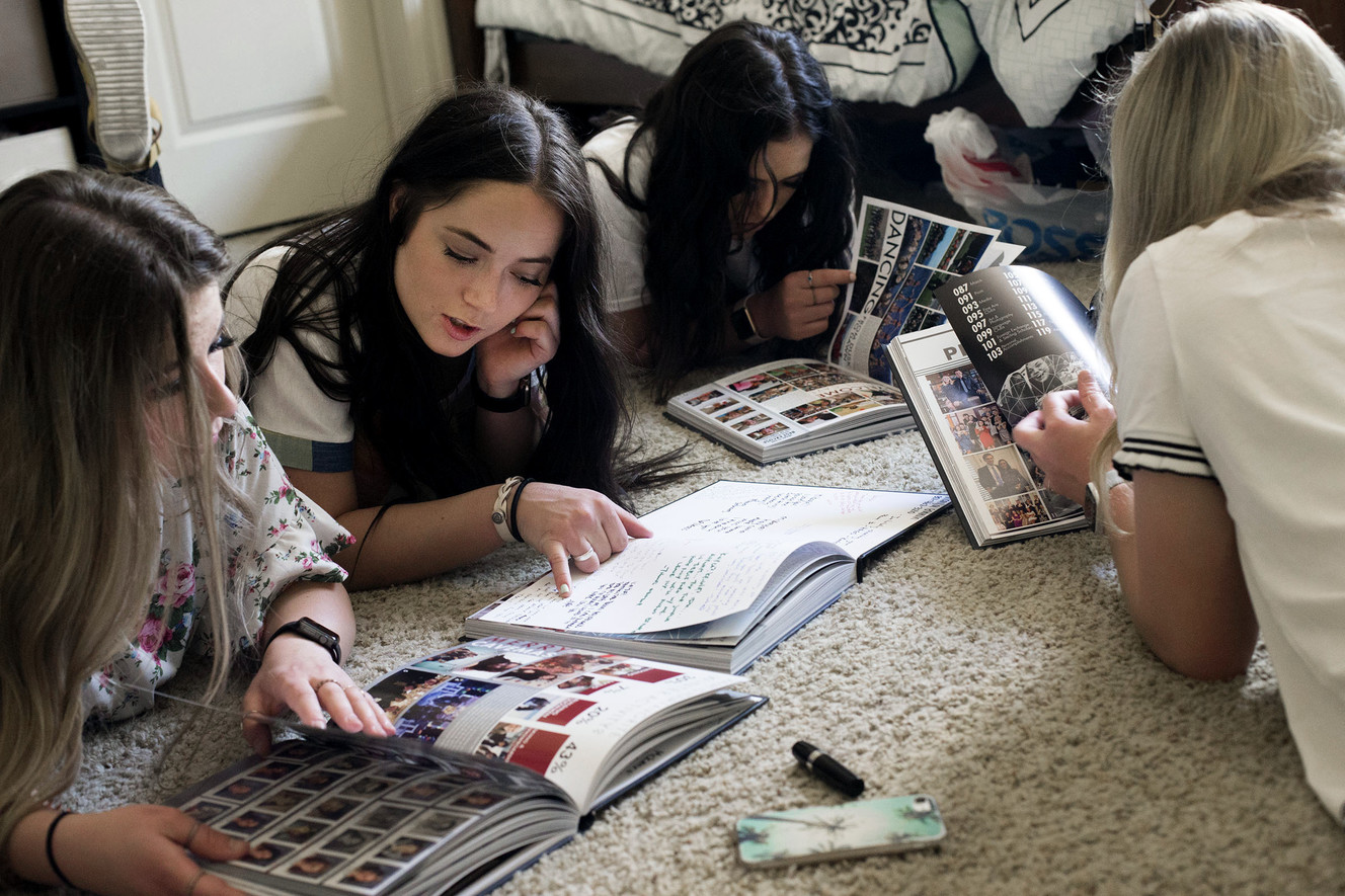 McKenna, Jade, Mikayla and Jordyn Godwin read their yearbooks at their Highland home on Tuesday, May 29, 2018. The quadruplets will graduate from American Fork High School on Thursday. (Photo: Laura Seitz, KSL)