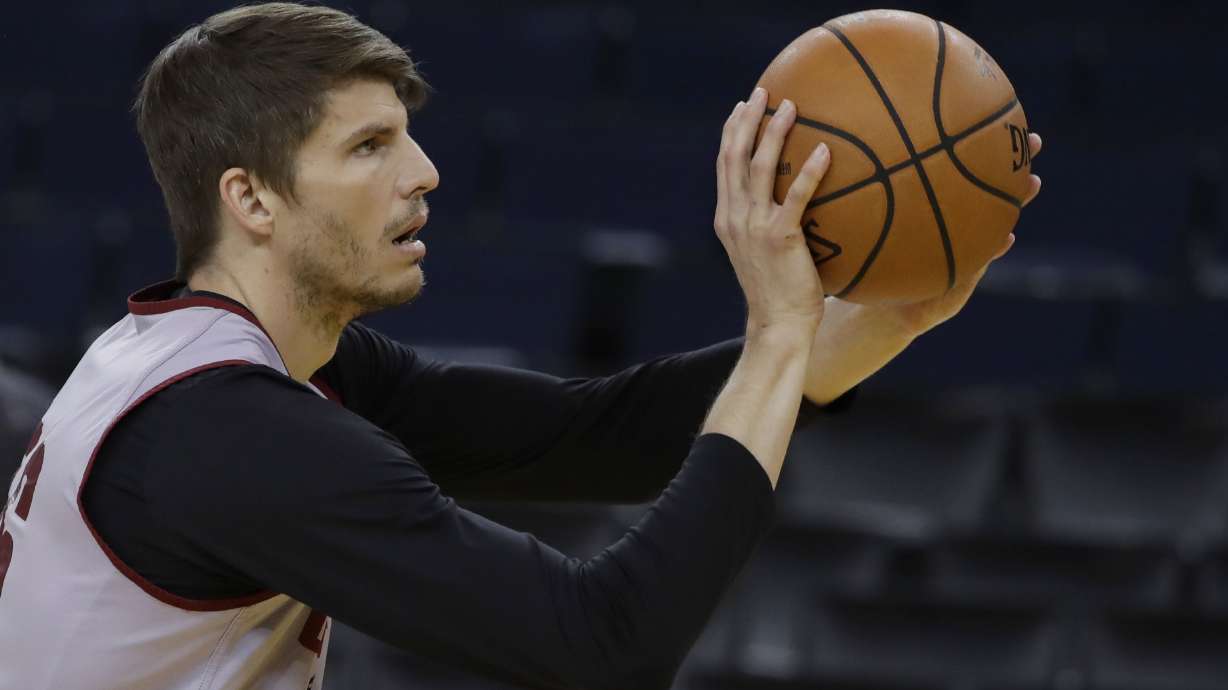 The Latest: Warriors top Cavs 124-114 in OT to open finals