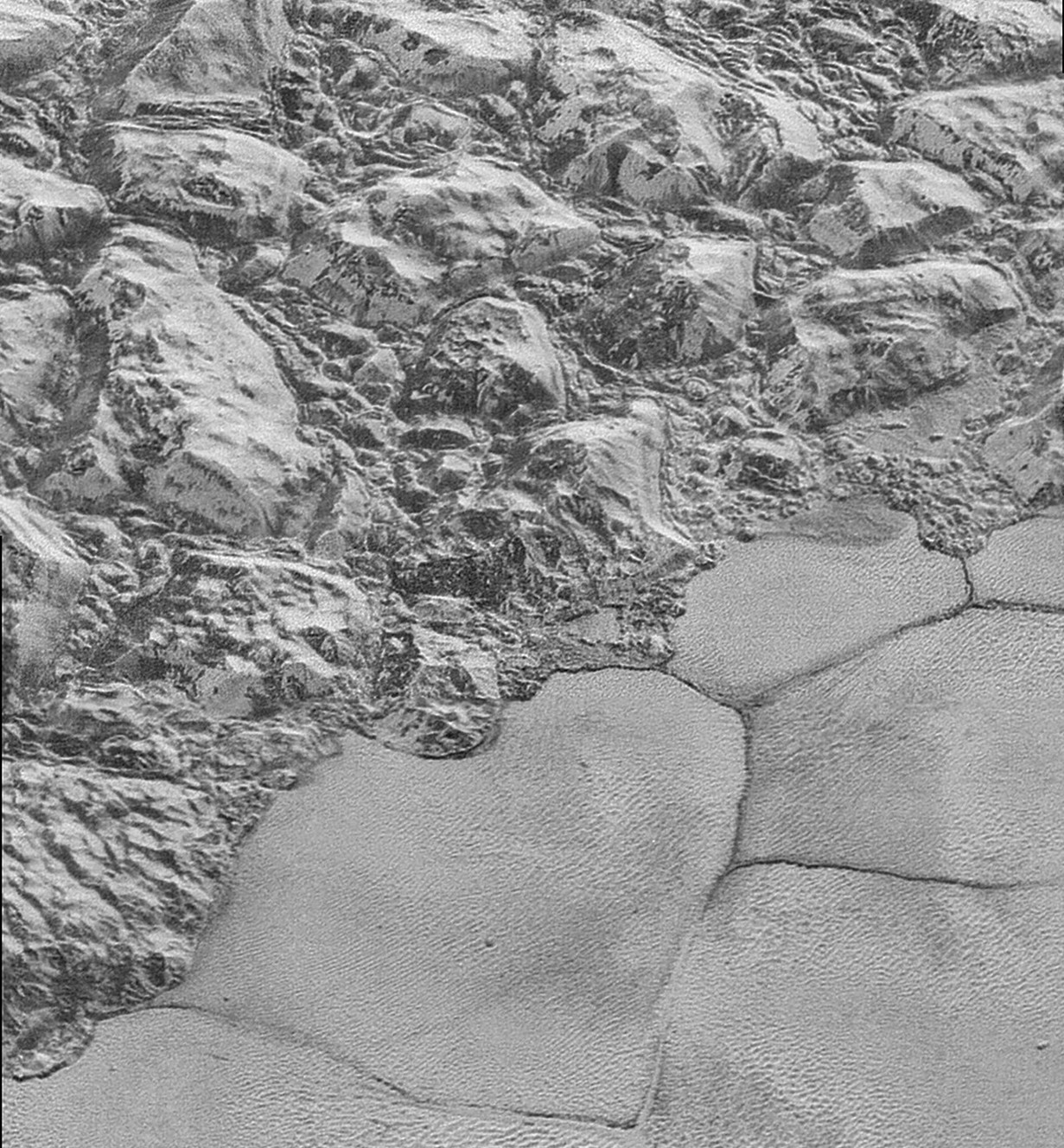 A NASA photo taken during the New Horizon's mission shows the mountain range on the edge of Sputnik Planitia on Pluto. Dune formations hug the bottom of the mountain range. (Photo: NASA/Johns Hopkins University Applied Physics Laboratory/Southwest Research Institute)