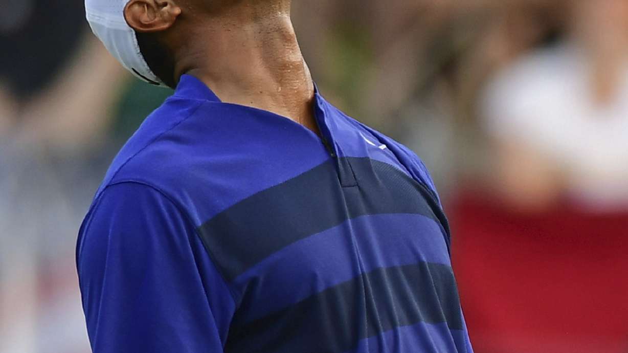 Dramatic eagle helps keep Woods in weekend mix at Memorial