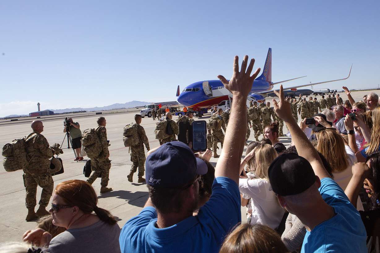 Friends and family wave goodbye to Utah National Guard soldiers being deployed to the Middle East at the Roland R. Wright Air National Guard Base in Salt Lake City on Monday, June 4, 2018. (Photo: James Wooldridge, KSL)