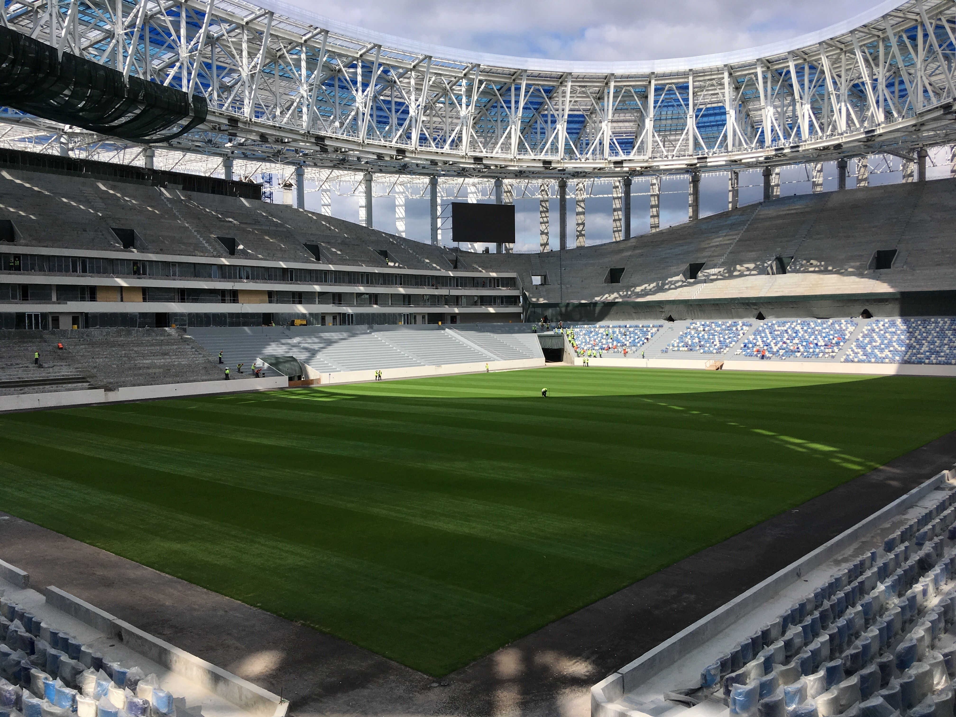 FILE - In this Saturday, Aug. 26, 2017 filer, laborers work at the construction site of the 2018 World Cup Nizhny Novgorod stadium, in Nizhny Novgorod, Russia. (James Ellingworth, AP Photo, File)