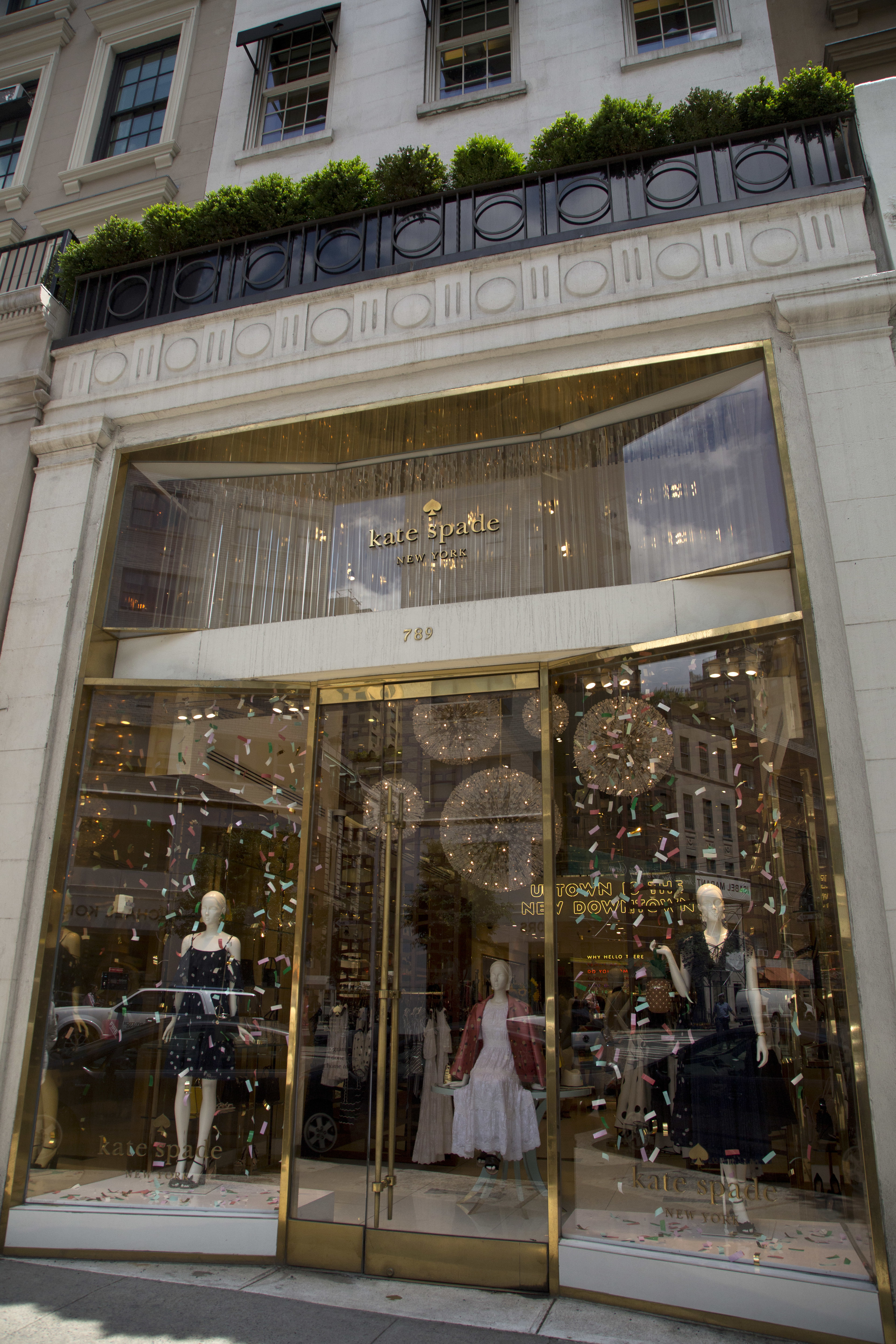 Kate Spade fashions are shown in the window of the fashion designer's Madison Avenue store, Tuesday, June 5, 2018, in New York. Law enforcement officials say Kate Spade has been found dead in her apartment in an apparent suicide. (AP Photo/Mark Lennihan)