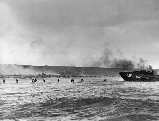 Under the cover of naval shell fire, American infantrymen wade ashore from their landing craft during the initial Normandy landing operations in France, June 6, 1944. (AP Photo/Peter Carroll)