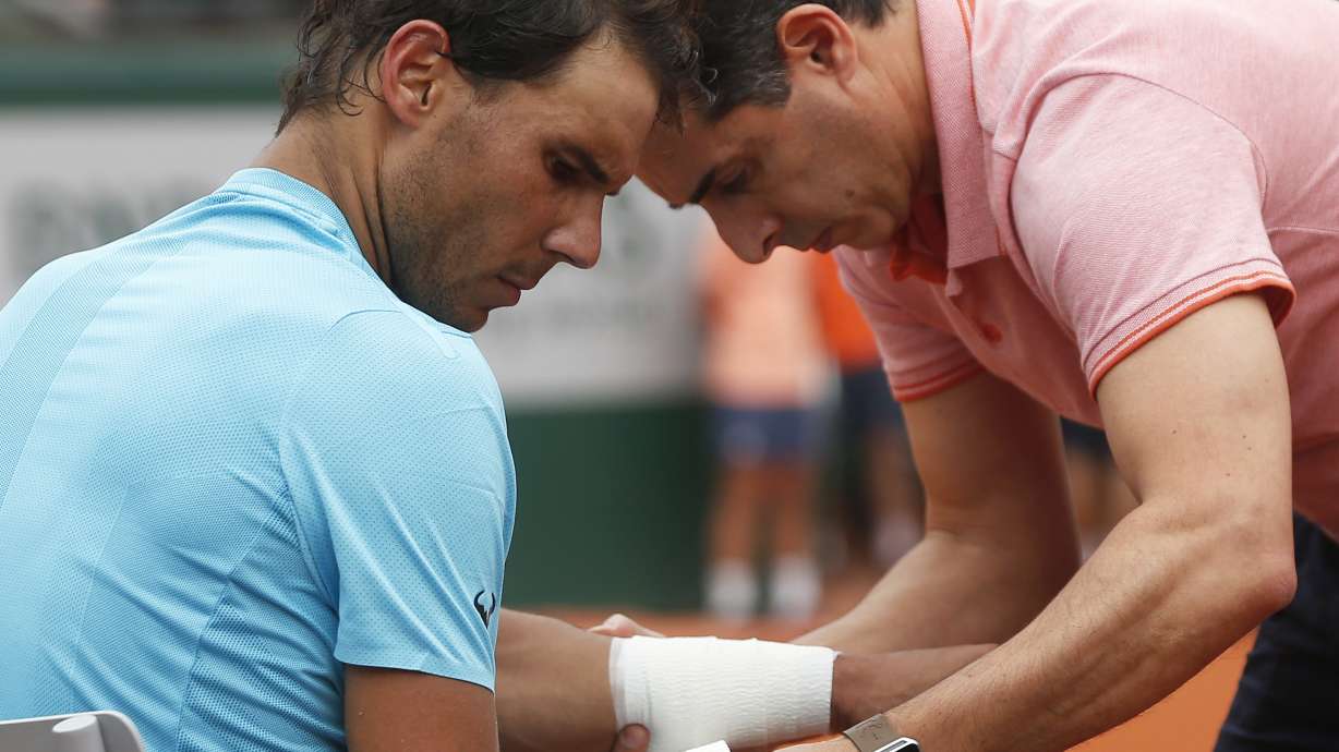 Nadal drops set, but rain suspends French Open quarterfinal