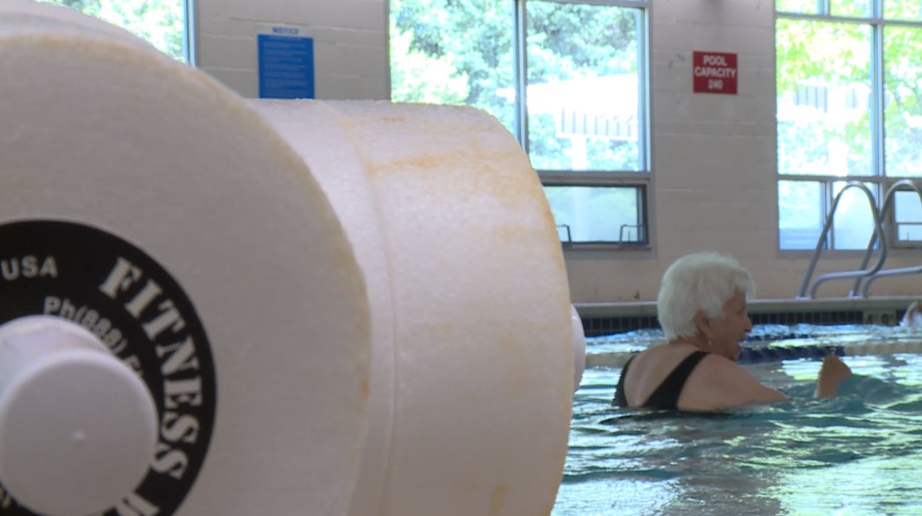 Although water aerobics is a non-weight bearing activity, the students do use weights to help strengthen their muscles. (Photo: KSL TV)