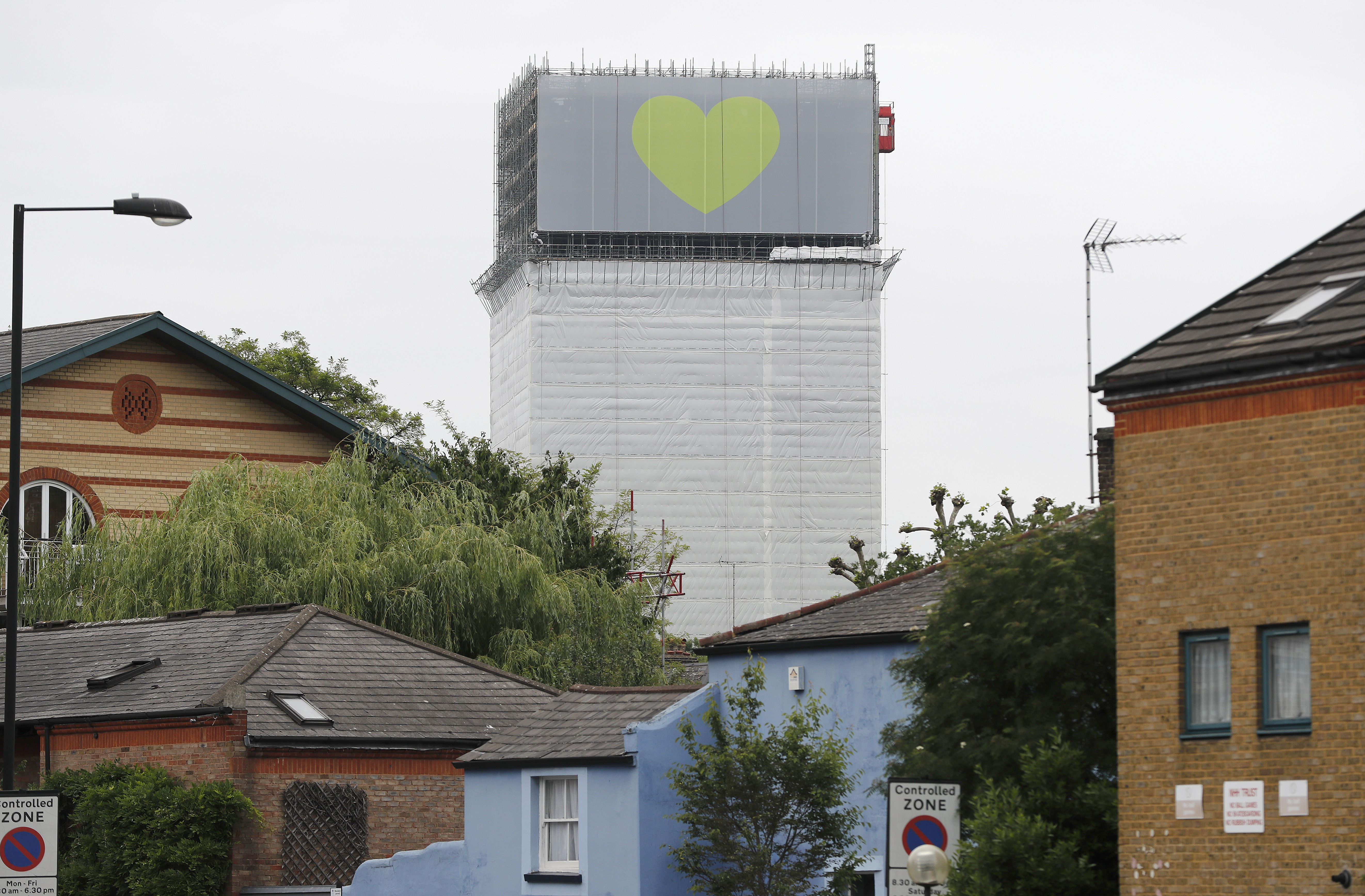 Banners wrapped on skeleton of London's Grenfell Tower