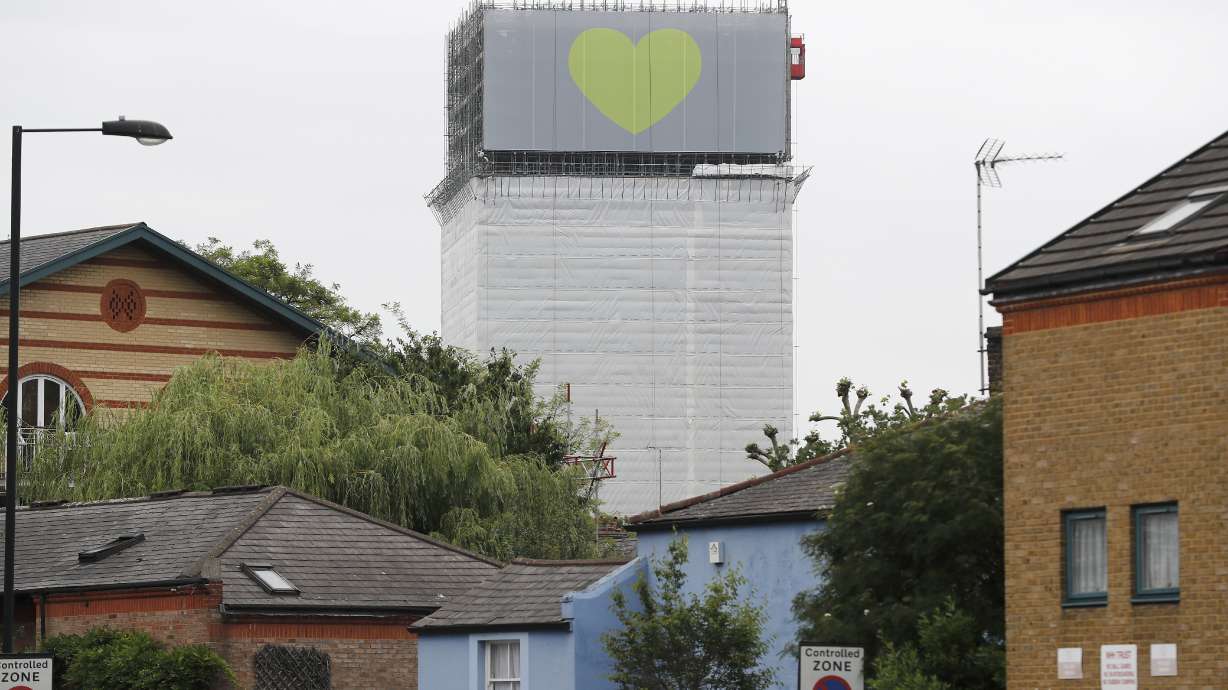 Banners wrapped on skeleton of London's Grenfell Tower