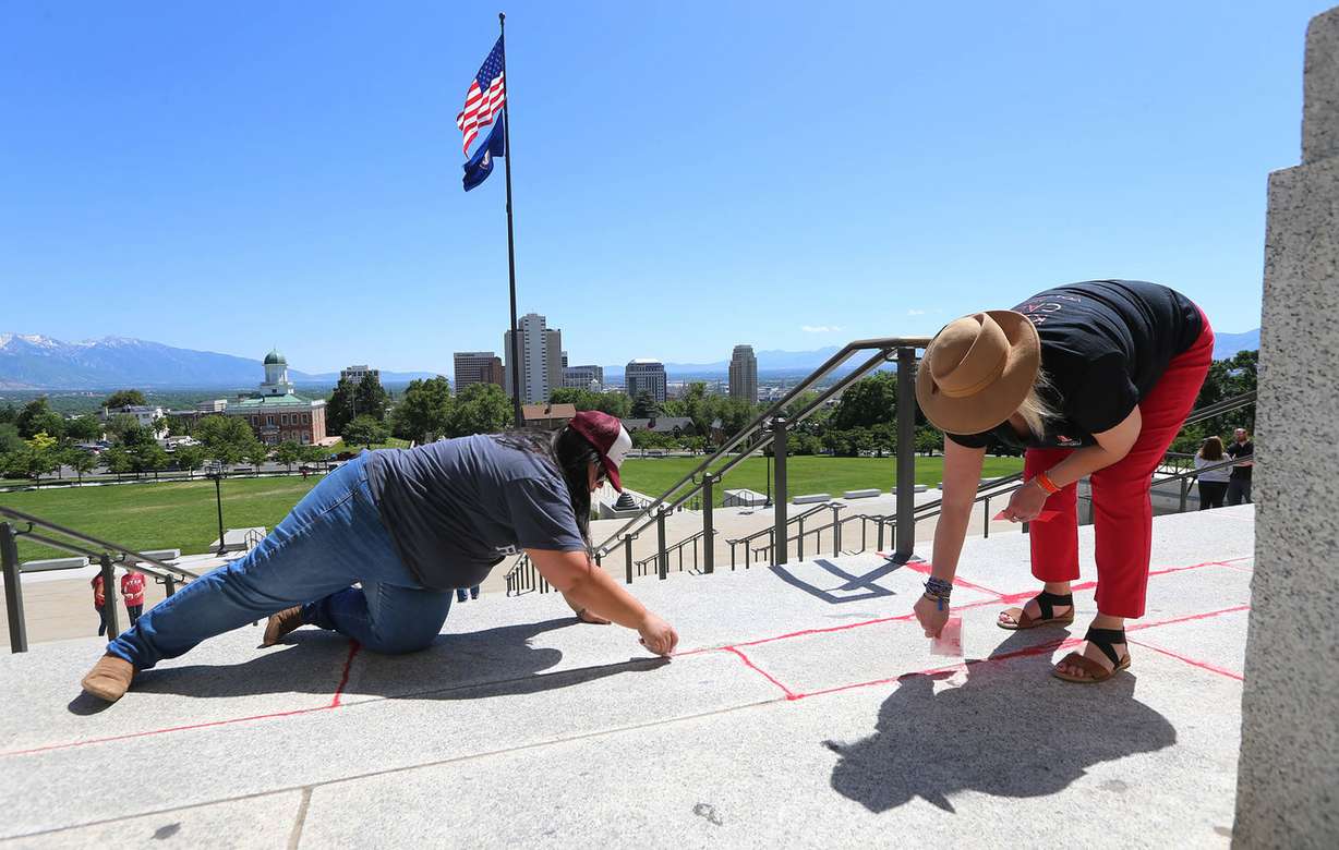 The Red Sand Project is an interactive art exhibition designed to raise awareness of human trafficking. By placing red sand in concrete cracks, the project brings attention to those who have fallen through the cracks in society. (Photo: Scott G Winterton, KSL)