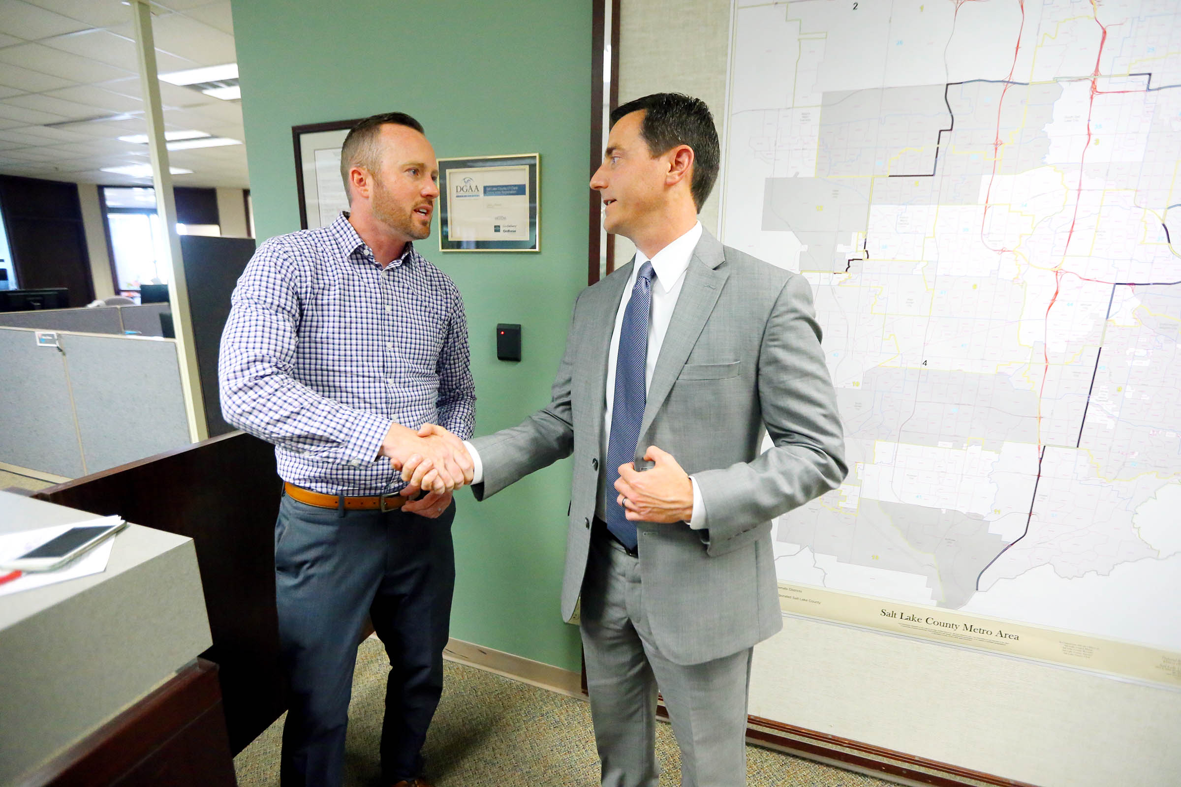 Herriman resident Justin Swain and Riverton Mayor Trent Staggs shake hands after filing an application for a referendum at the Salt Lake County Clerk's Office in Salt Lake City on Monday, June 11, 2018. (Photo: Scott G. Winterton, KSL)