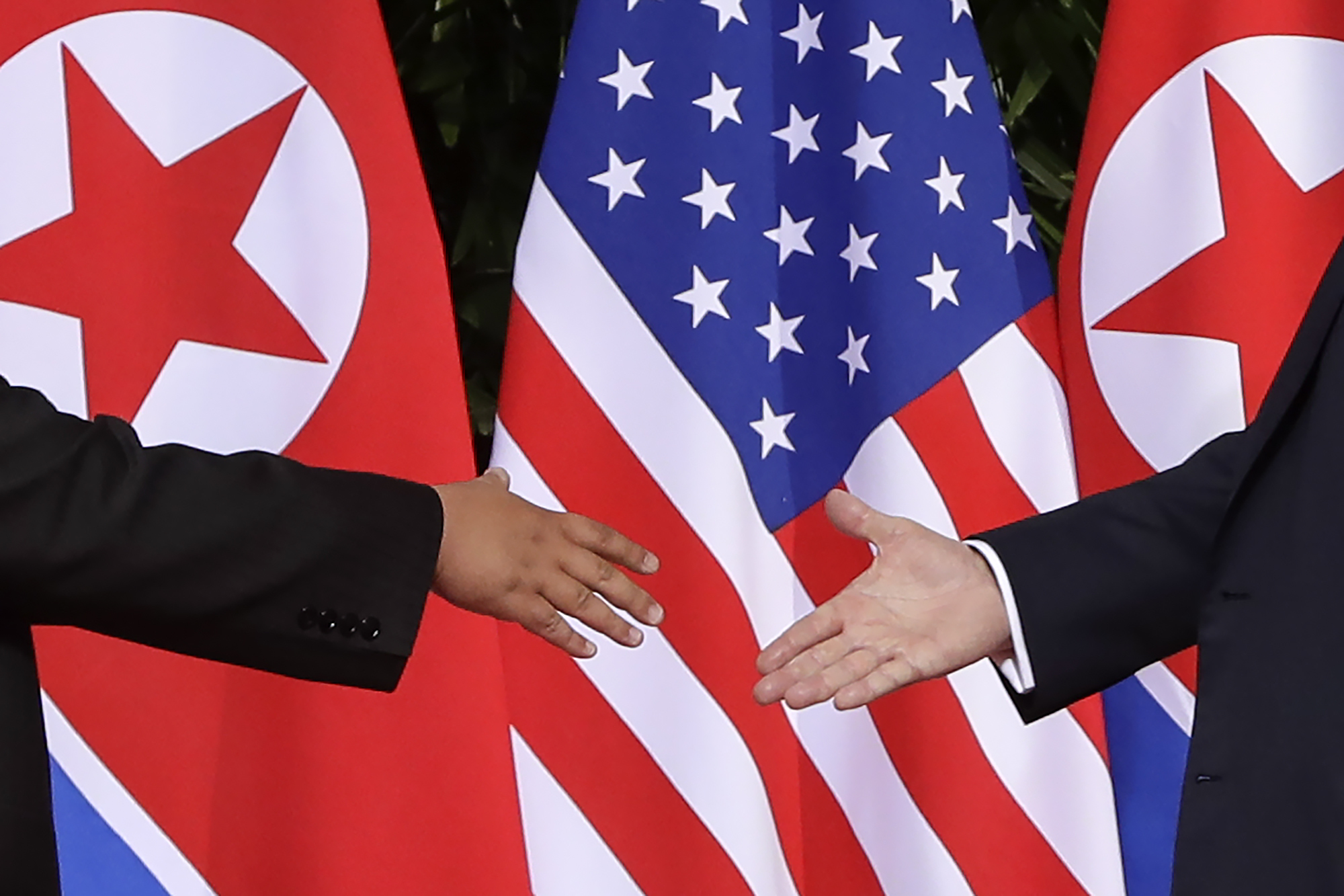 Trump and Kim shake hands in scene complex as their rivalry