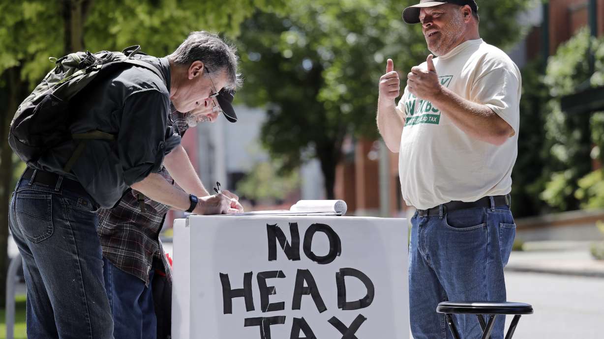 The Latest: Seattle repeals tax on companies like Amazon