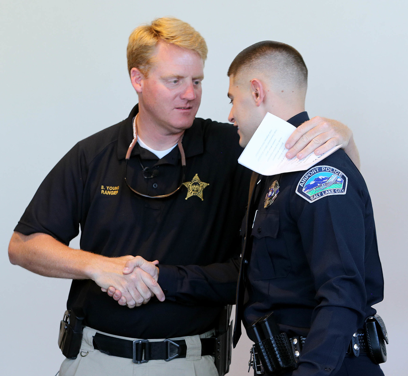 Moab park ranger Brody Young congratulates Benjamin Francom during the Utah Peace Officers Association's annual scholarship awards ceremony in Salt Lake City on Tuesday, June 12, 2018. (Photo: Scott G Winterton, KSL)