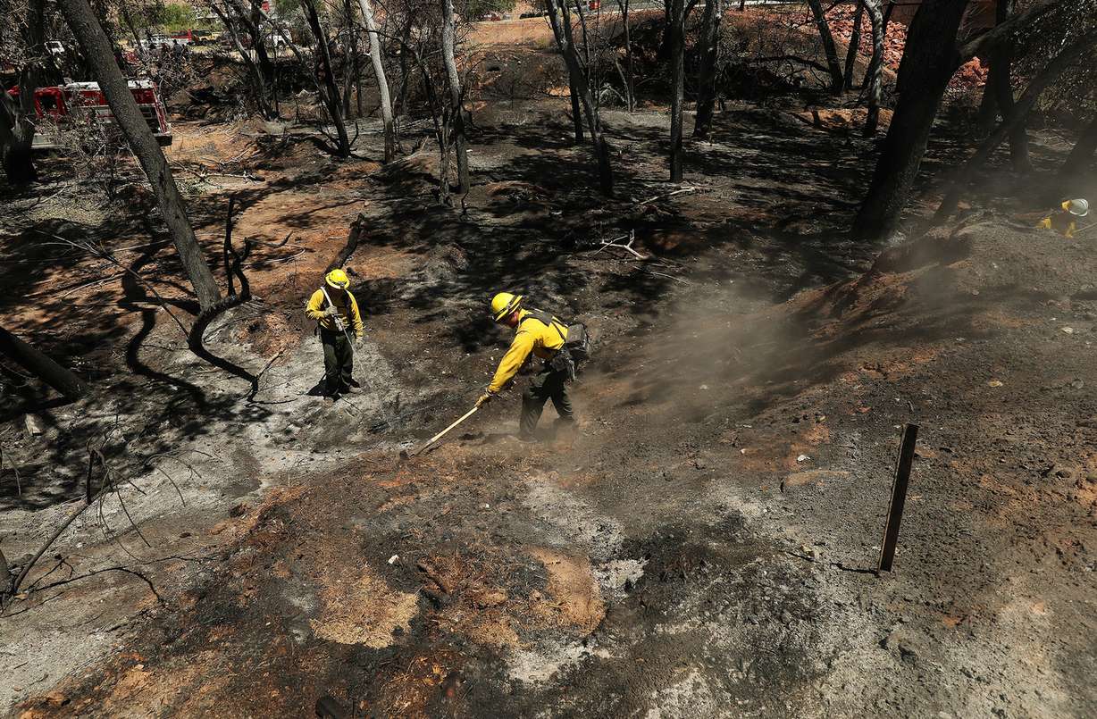 North Logan firefighters mop up after a fire destroyed eight homes, two garages and a shop near Pack Creek in Moab on Wednesday, June 13, 2018. (Photo: Jeffrey D. Allred, KSL)