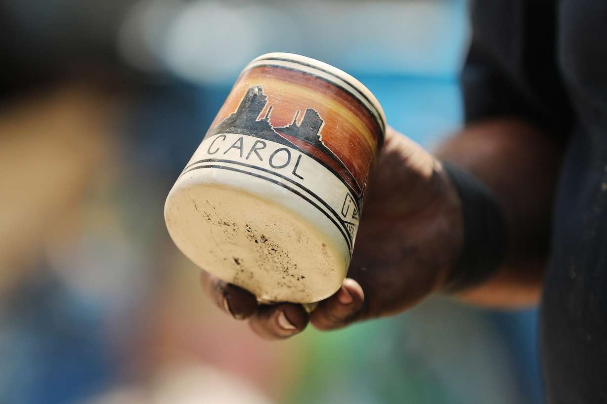 Rick Carrigan holds a mug that belonged to his mother while looking over damage to his home on Thursday, June 14, 2018. A fire on Tuesday destroyed several homes in Moab. (Photo: Jeffrey D. Allred, KSL)