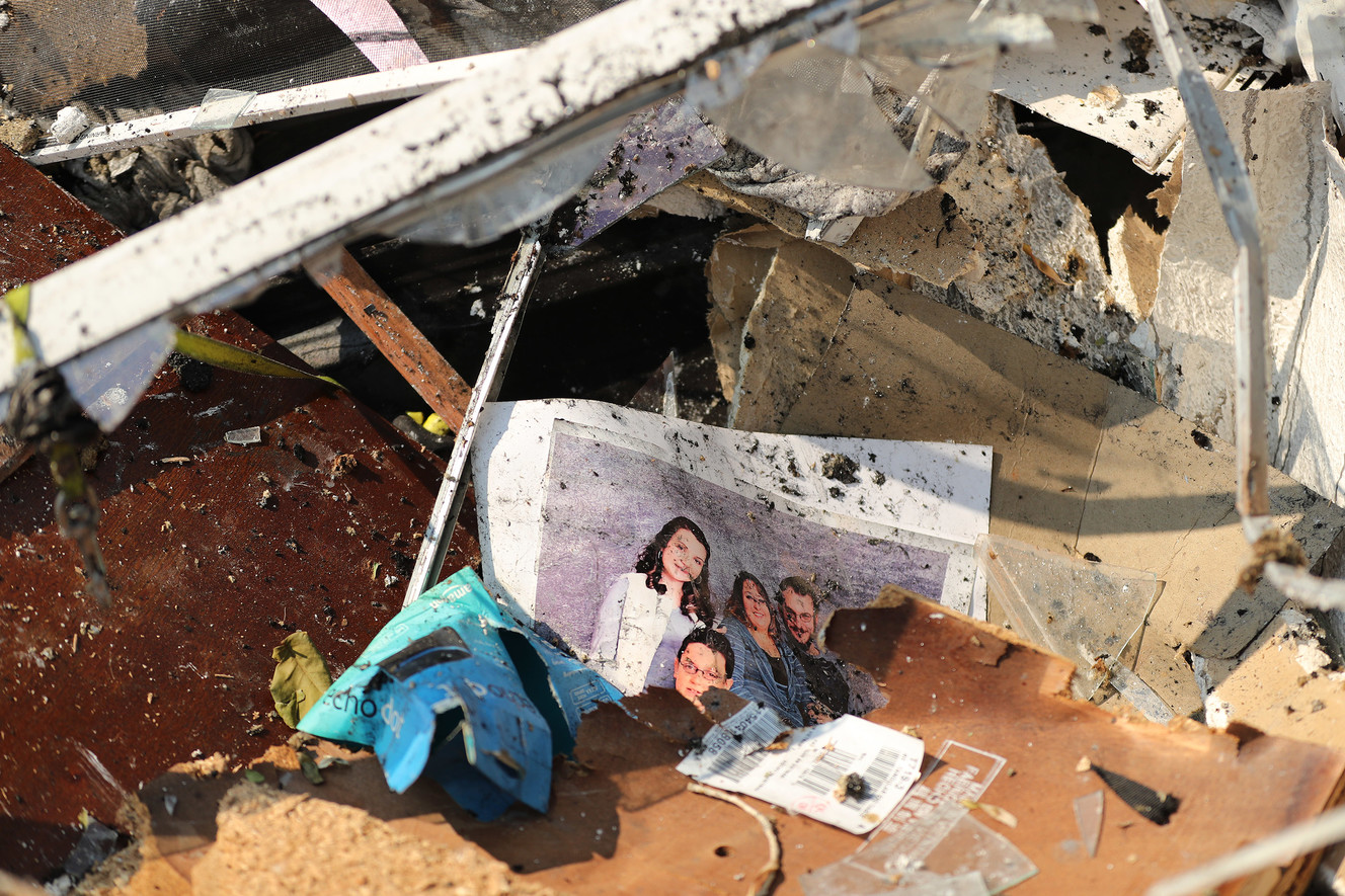A photo lays in the rubble on Thursday, June 14, 2018, in Moab after a fire destroyed several homes on Tuesday. (Photo: Jeffrey D. Allred, KSL)