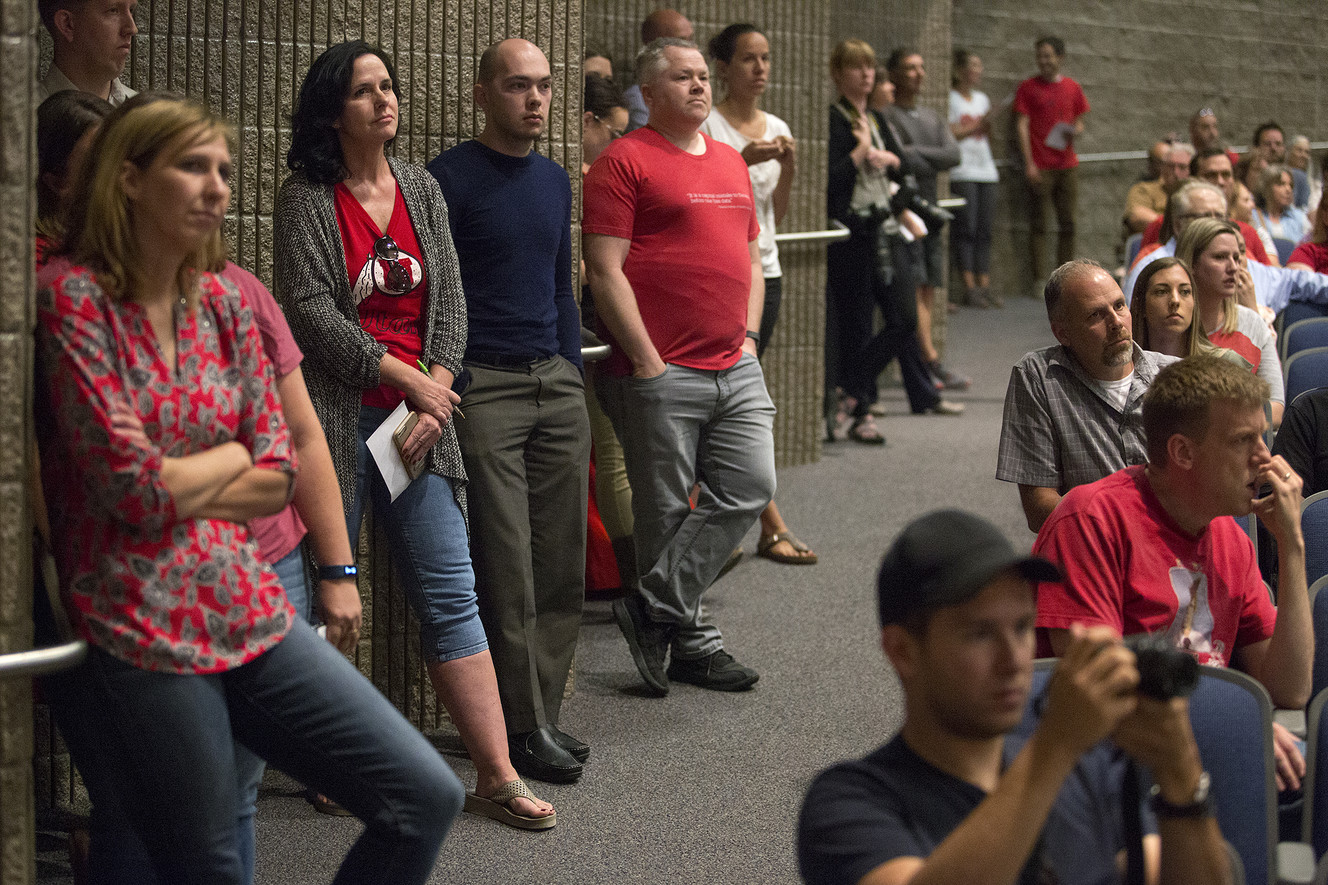 Sonia Salari, left center, Brian Flach, Steve Catmull, and other community members wait to speak about the Olympia Hills development proposal at a town hall meeting in Herriman High School on Thursday, June 14, 2018. (Photo: James Wooldridge, KSL)
