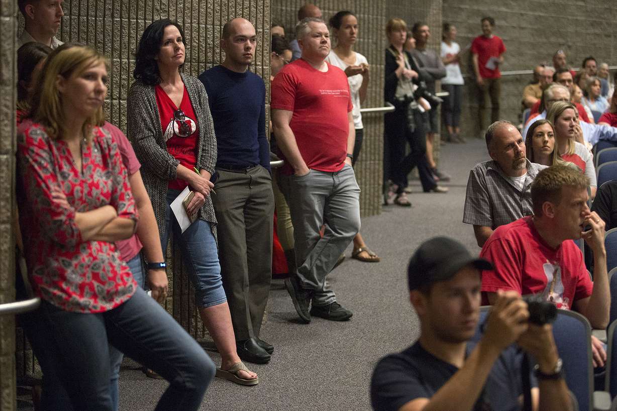 Sonia Salari, left center, Brian Flach, Steve Catmull, and other community members wait to speak about the Olympia Hills development proposal at a town hall meeting in Herriman High School on Thursday, June 14, 2018. (Photo: James Wooldridge, KSL)