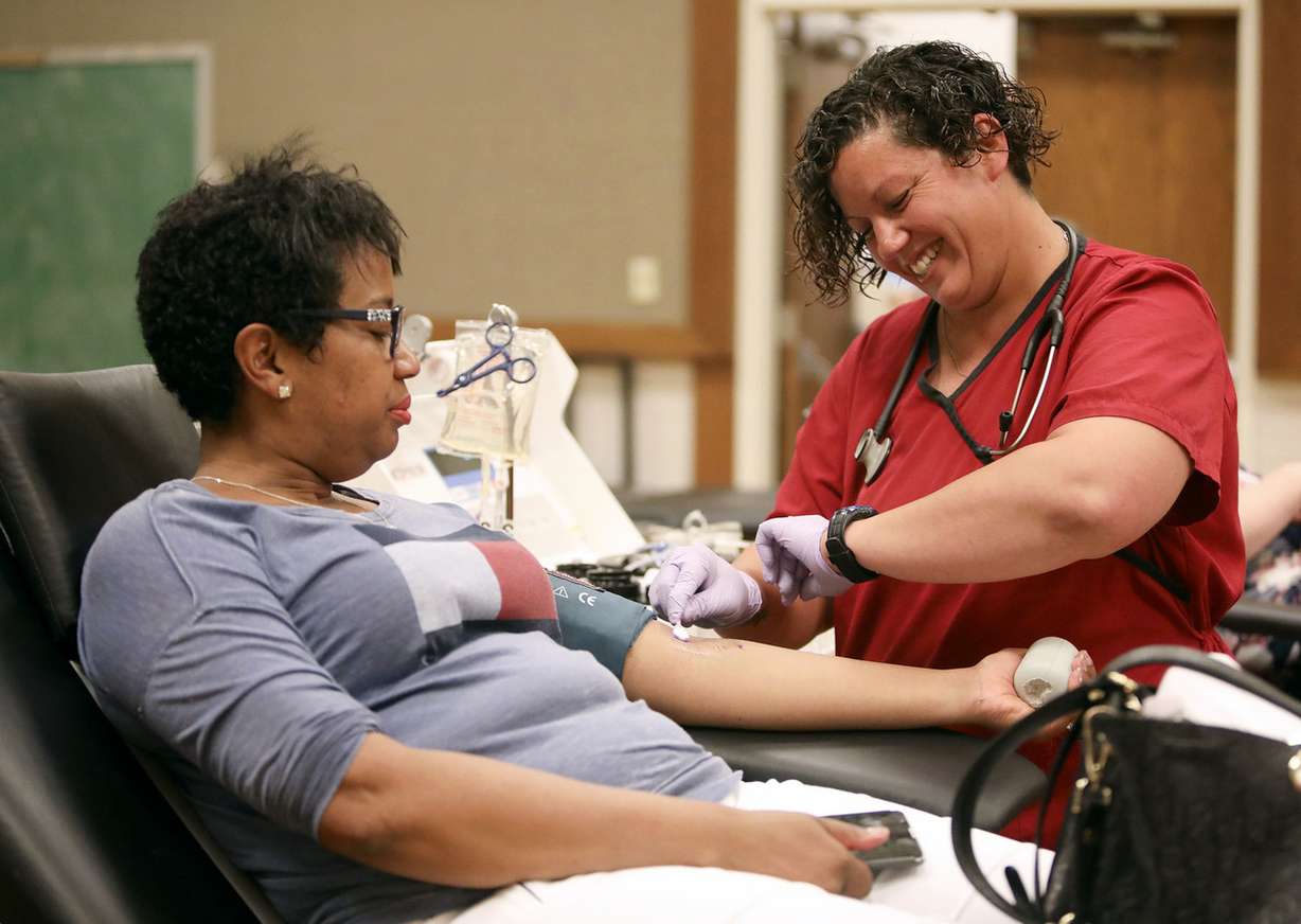 Kristin Murray, phlebotomist, sterilizes a section of Michelle Williams' arm before drawing blood at a community blood drive at a Taylorsville LDS Stake Center on Friday, June 15, 2018. (Photo: Kristin Murphy, KSL)