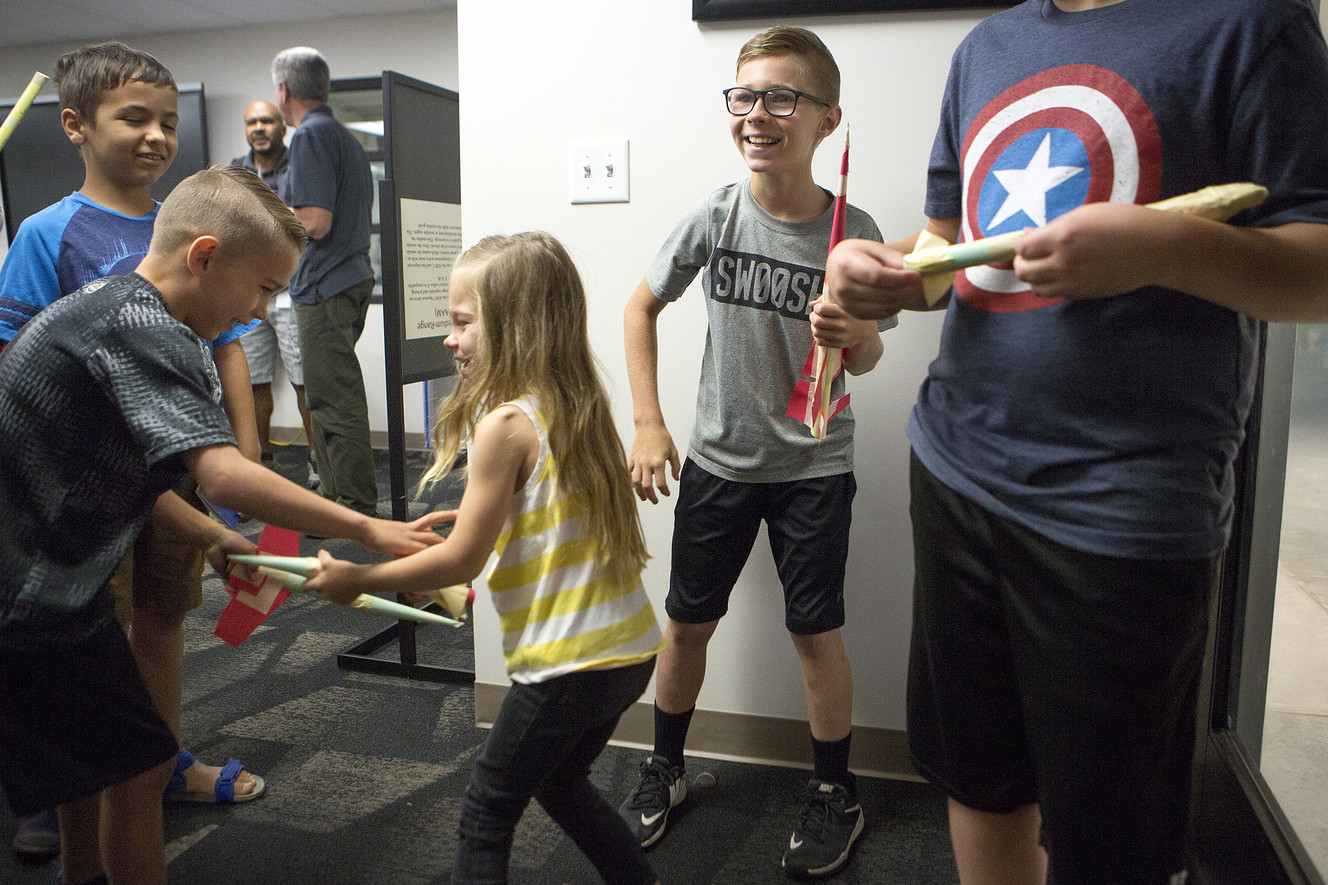 Matt Burgess, 10, right, and Andrew Larsen, 10, hold the paper rockets they built as Ryan Larsen, 7, and Kate Larsen, 4, grapple with their rockets during the Summer STEM Passport Program at the Hill Aerospace Museum on Saturday, June 16, 2018. (Photo: James Wooldridge, KSL)