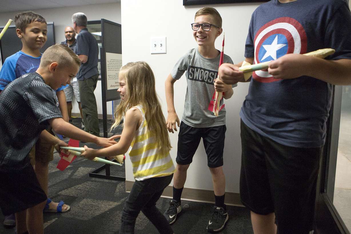 Matt Burgess, 10, right, and Andrew Larsen, 10, hold the paper rockets they built as Ryan Larsen, 7, and Kate Larsen, 4, grapple with their rockets during the Summer STEM Passport Program at the Hill Aerospace Museum on Saturday, June 16, 2018. (Photo: James Wooldridge, KSL)