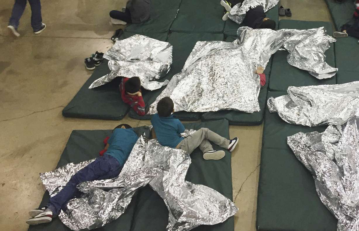 People who've been taken into custody related to cases of illegal entry into the United States rest in one of the cages at a facility in McAllen, Texas, Sunday, June 17, 2018. Photo: U.S. Customs and Border Protection
