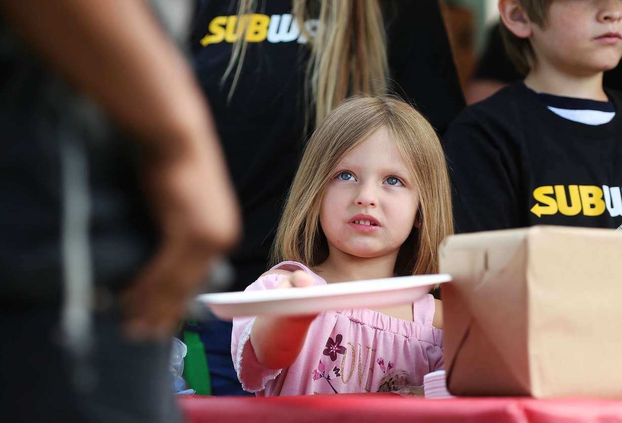 Breezly Tate hands out plates during Subway's 10th annual Day of Giving at Pioneer Park in Salt Lake City on Tuesday, June 19, 2018. (Photo: Scott G Winterton, KSL)