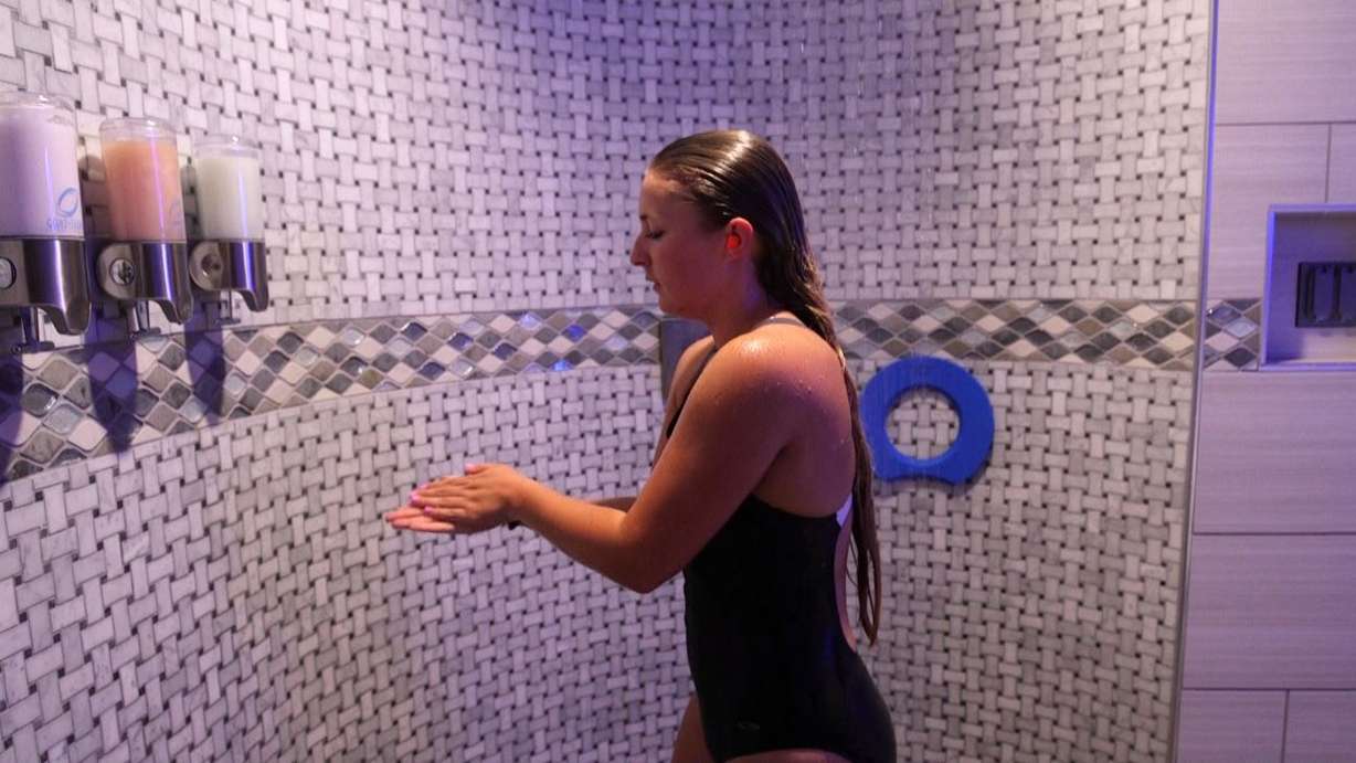 Haley Gustavson takes a shower with earplugs before jumping into the flotation tank. (Photo: KSL TV)