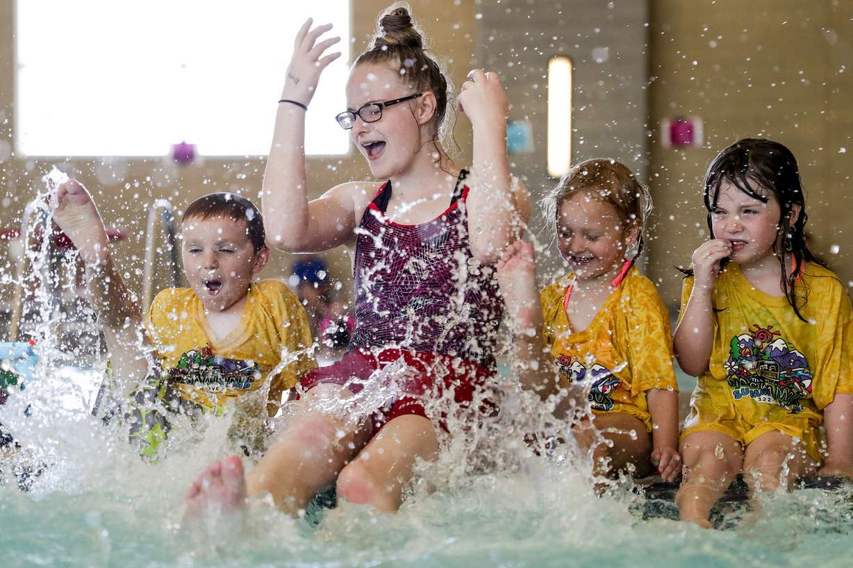 Swim instructor Grace Peterson kicks and splashes with Milo, Gwynn and Madelyn, all 5, during a mass swim lesson at the South Davis Recreation Center in Bountiful on Thursday, June 21, 2018. The recreation center was an official host site for the World’s Largest Swimming Lesson — an event taking place at pools and waterparks around the globe to focus attention on the vital importance of teaching kids to swim and prevent child drownings. (Photo: Spenser Heaps, KSL)