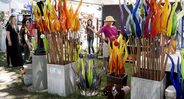 People admire the glass sculptures made by Stan Oneil at the Utah Arts Festival in Salt Lake City on Friday, June 22, 2018. (Photo: Laura Seitz, KSL)