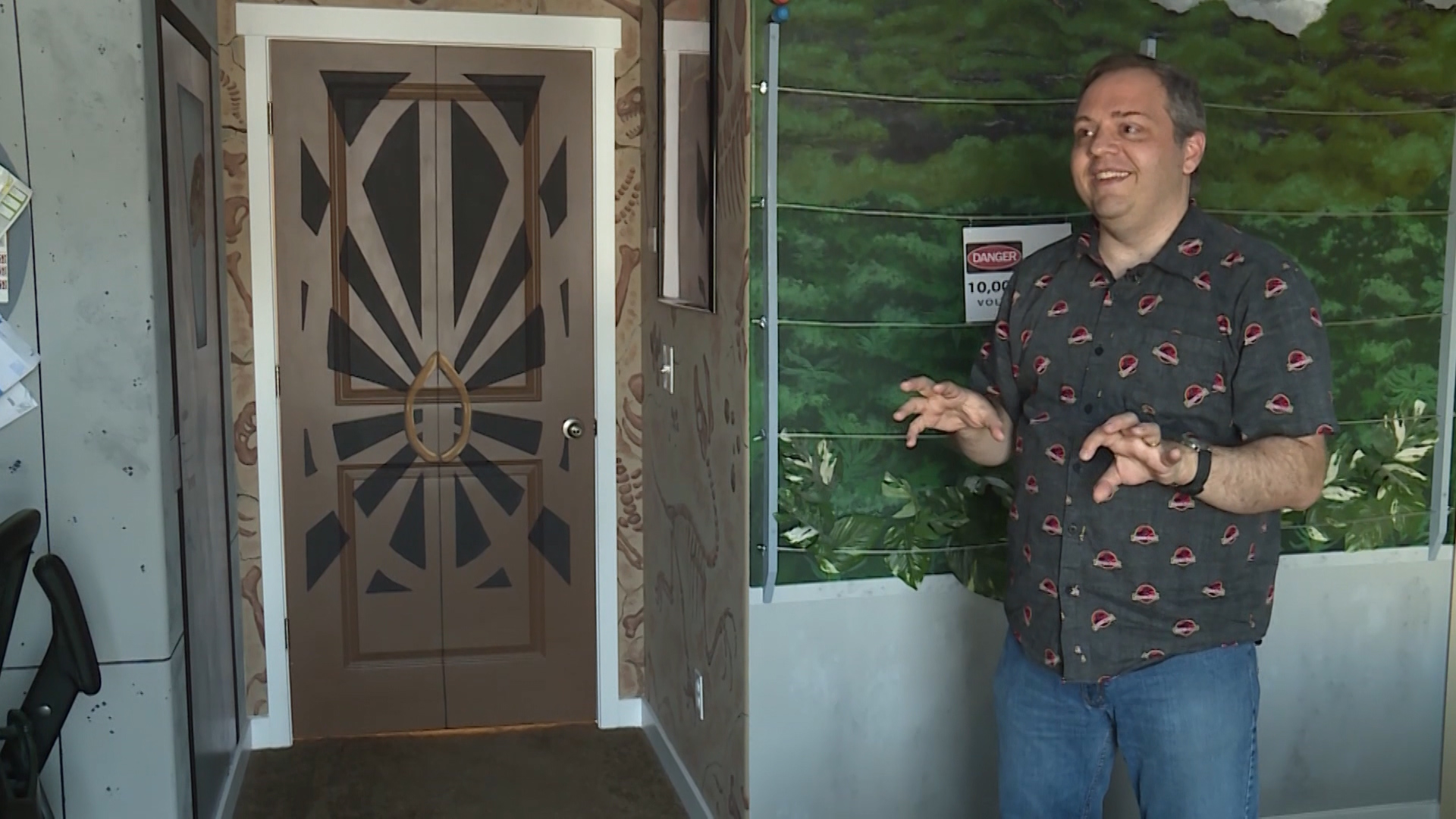 Andy Peterson shows off his newly remodeled "Jurassic Park" bedroom. The classic dinosaur movie-themed room was created in celebration Peterson and his wife's 20th wedding anniversary. (Photo: Ray Boone, KSL TV)